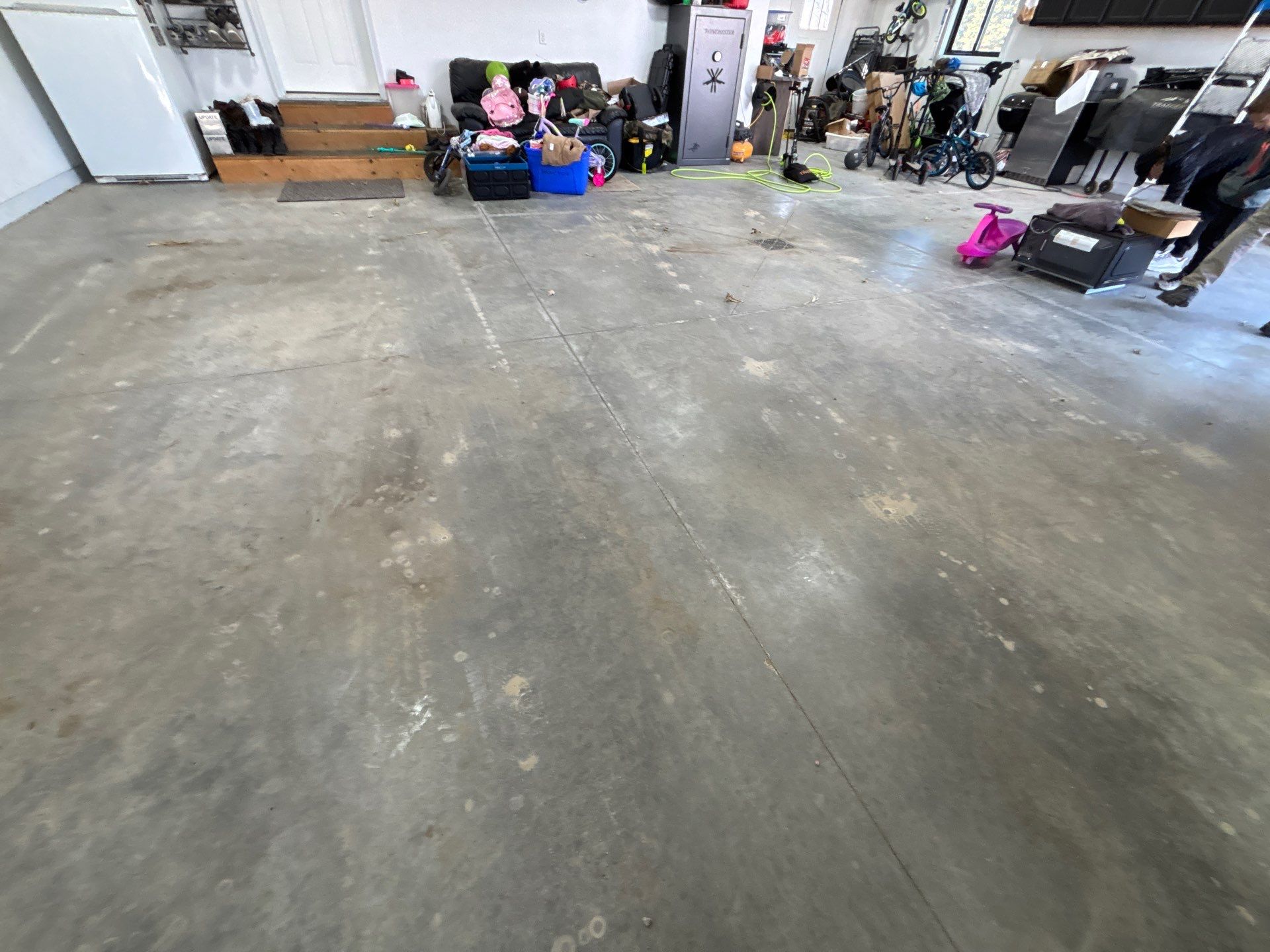 Speckled Polyaspartic Garage Floor Coating Installation in Dell Rapids by Select Painting, Coatings & Garage Cabinets