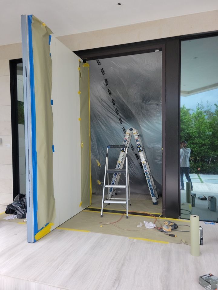 Custom Material Pivot Door installation by Impact Precious Wood Inc.