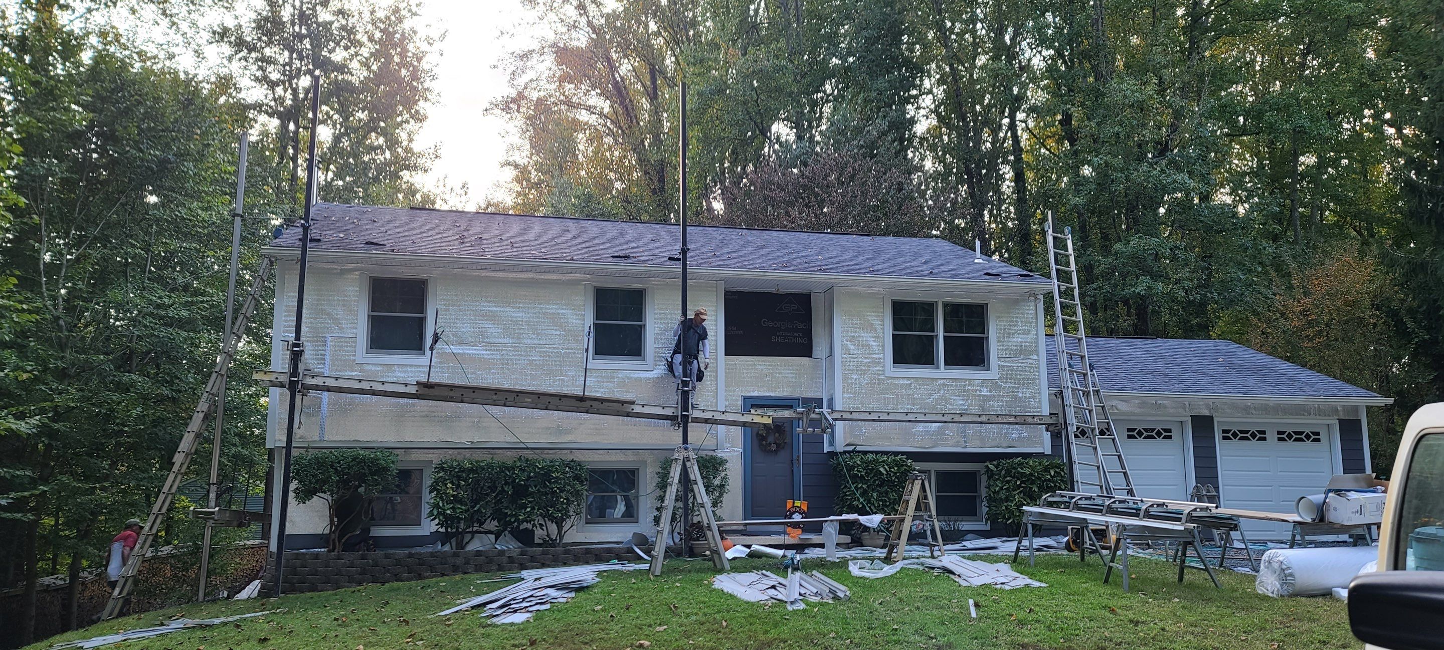 New James Hardie siding in Night Gray and Arctic White trim with LowE Wrap by Window Depot of Annapolis