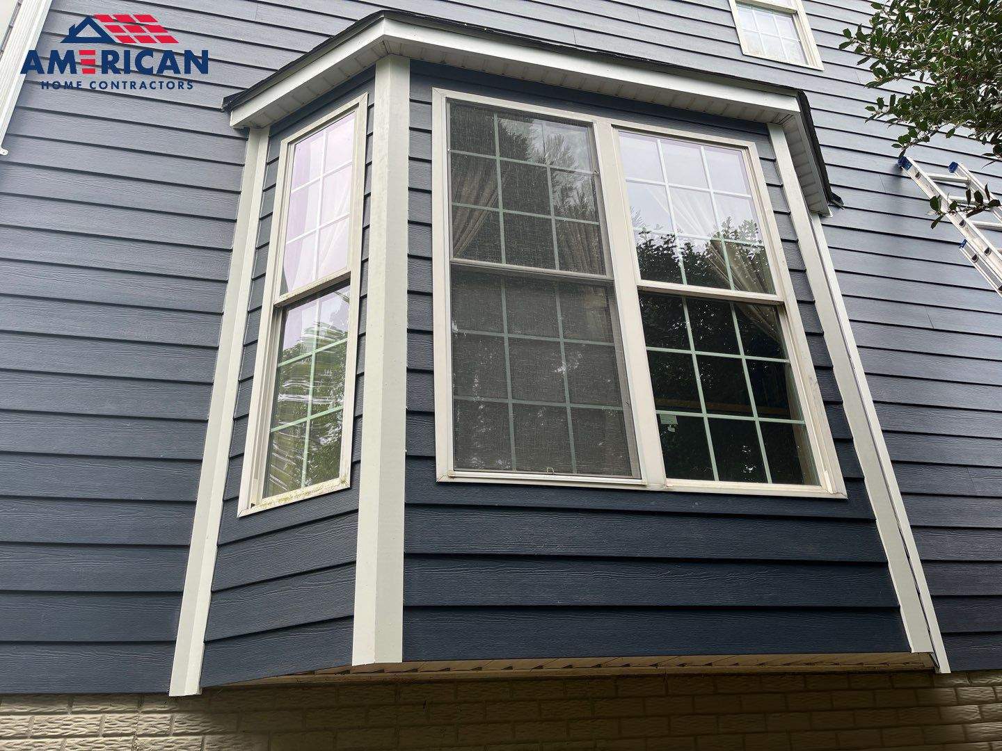 James Hardie Plank Siding + Seamless Gutters by American Home Contractors