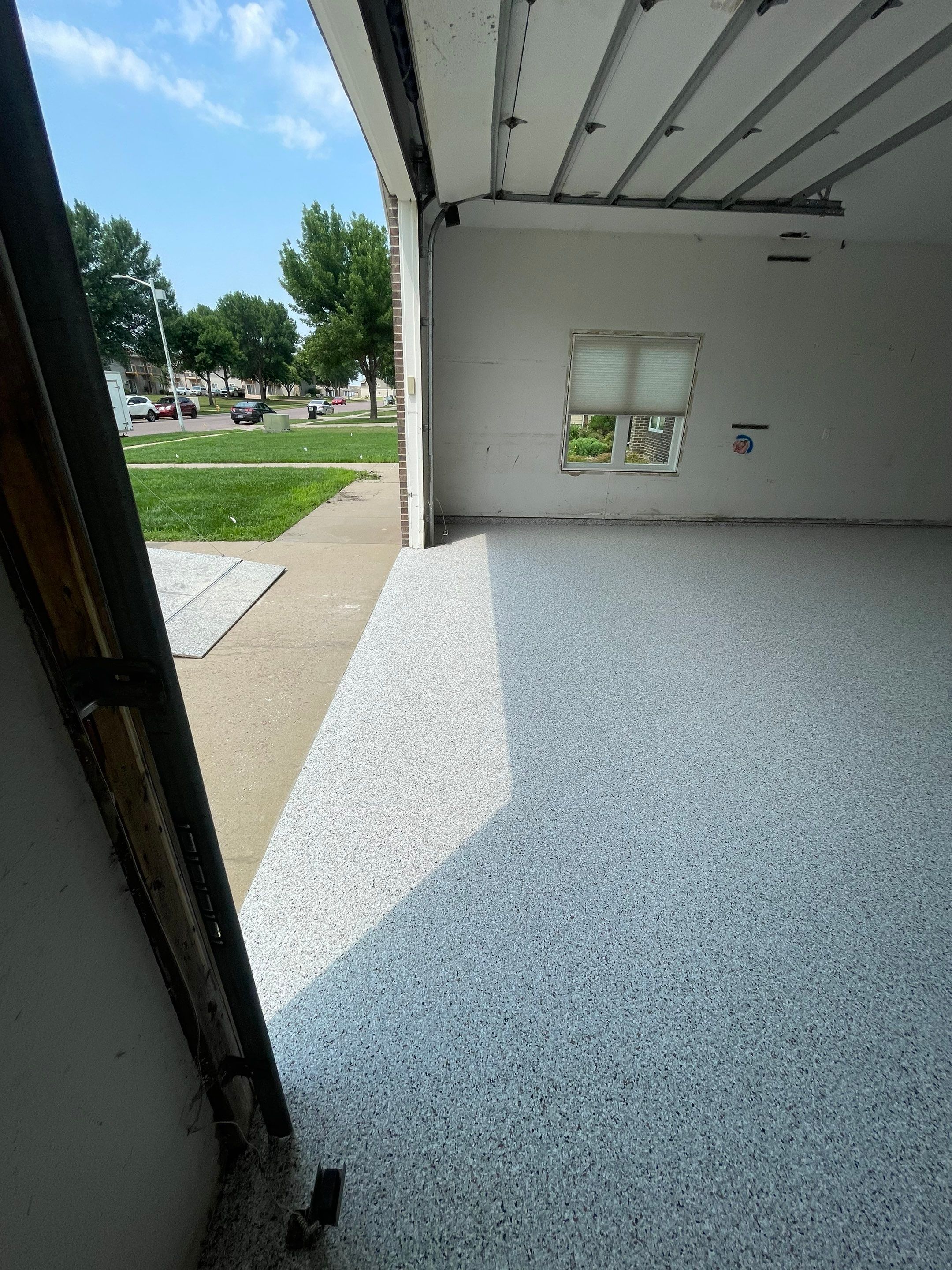 Coyote Flake Concrete Coating for Sioux Falls Garage by Select Painting, Coatings & Garage Cabinets