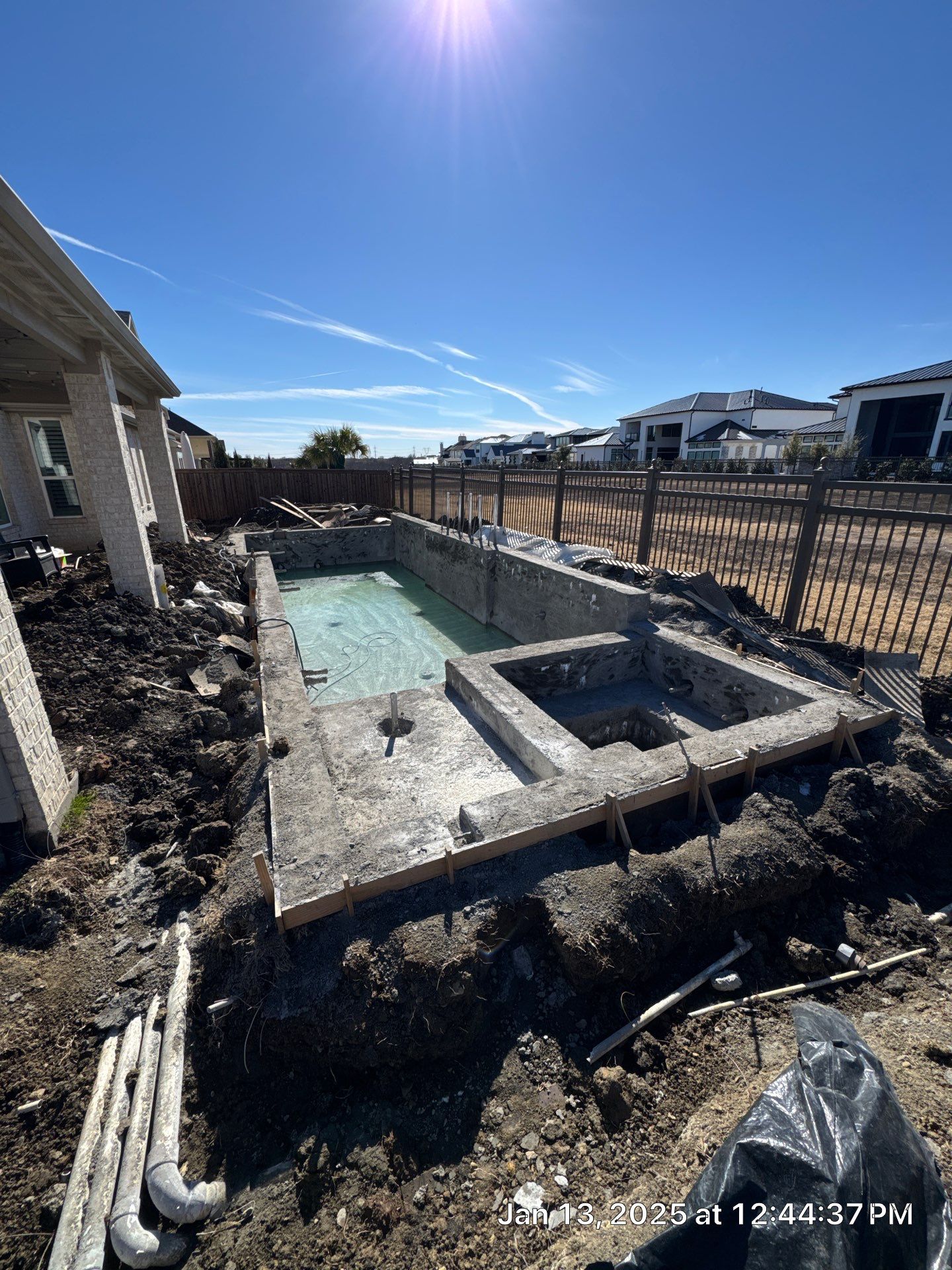 Geometric Pool with Raised Stone Scupper Wall and Outdoor Kitchen by Pinnacle Pools and Spas - DFW