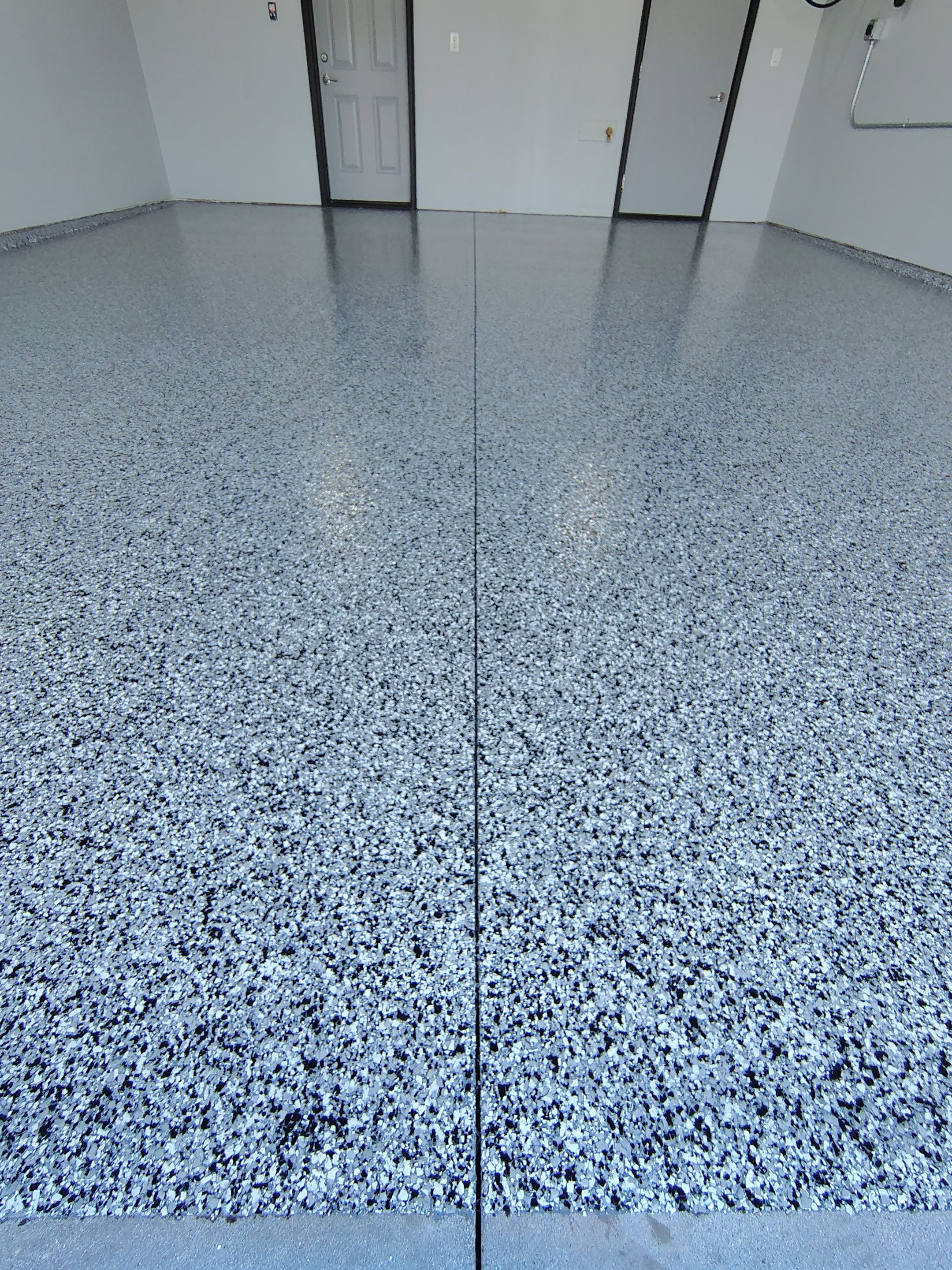 Custom Epoxy Garage Floor Coating Installation in Sioux Falls by Select Painting, Coatings & Garage Cabinets