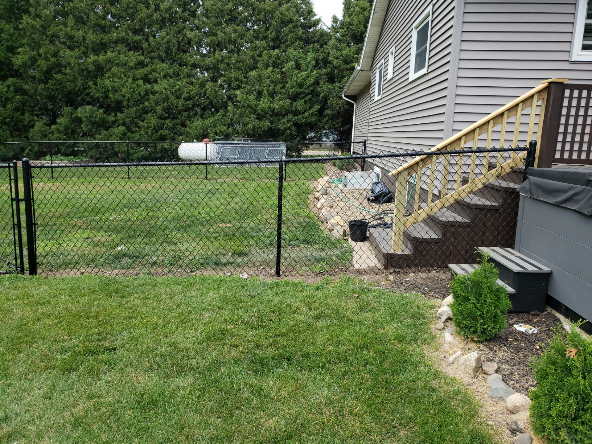 Black Vinyl-Coated Chain Link Fence Installation in Fredericksburg by Perfect Picket Fence and Stain