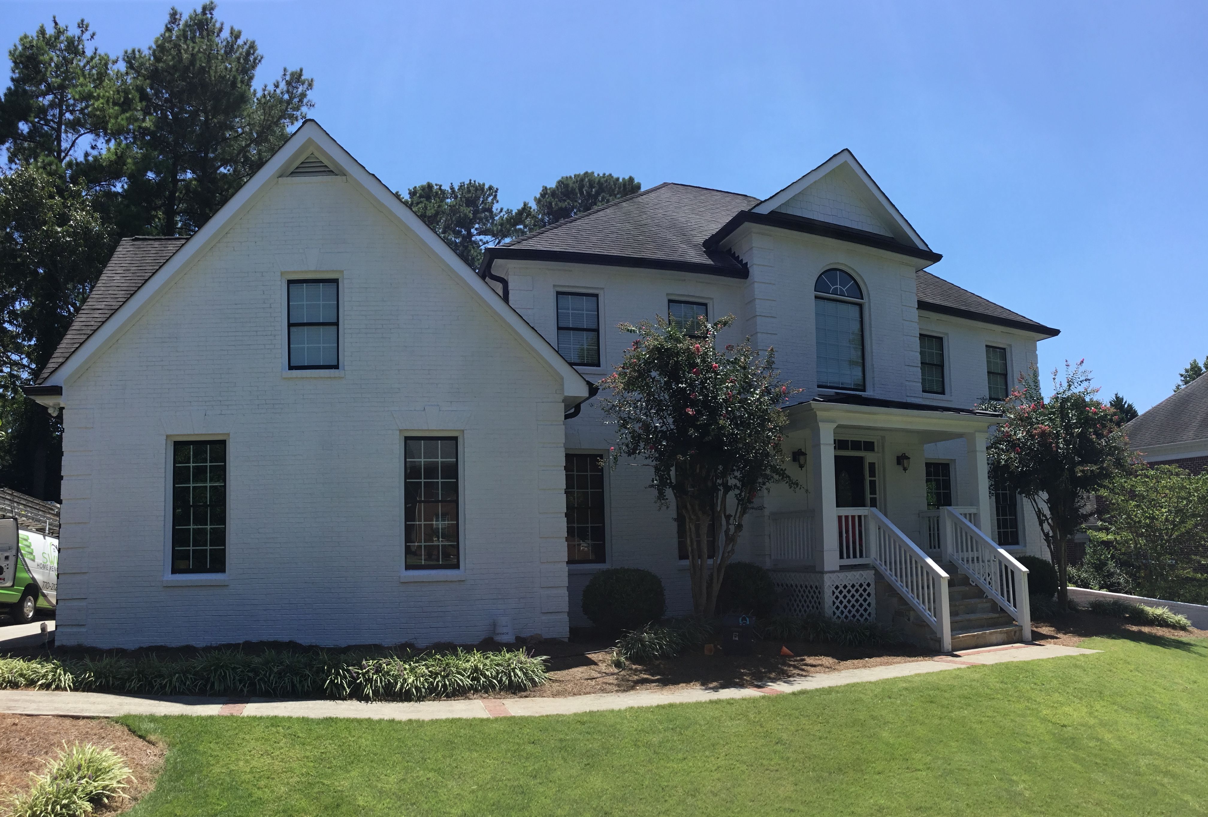 Custom Front Porch Construction with White Railing in Dunwoody by Swift Home Renovations
