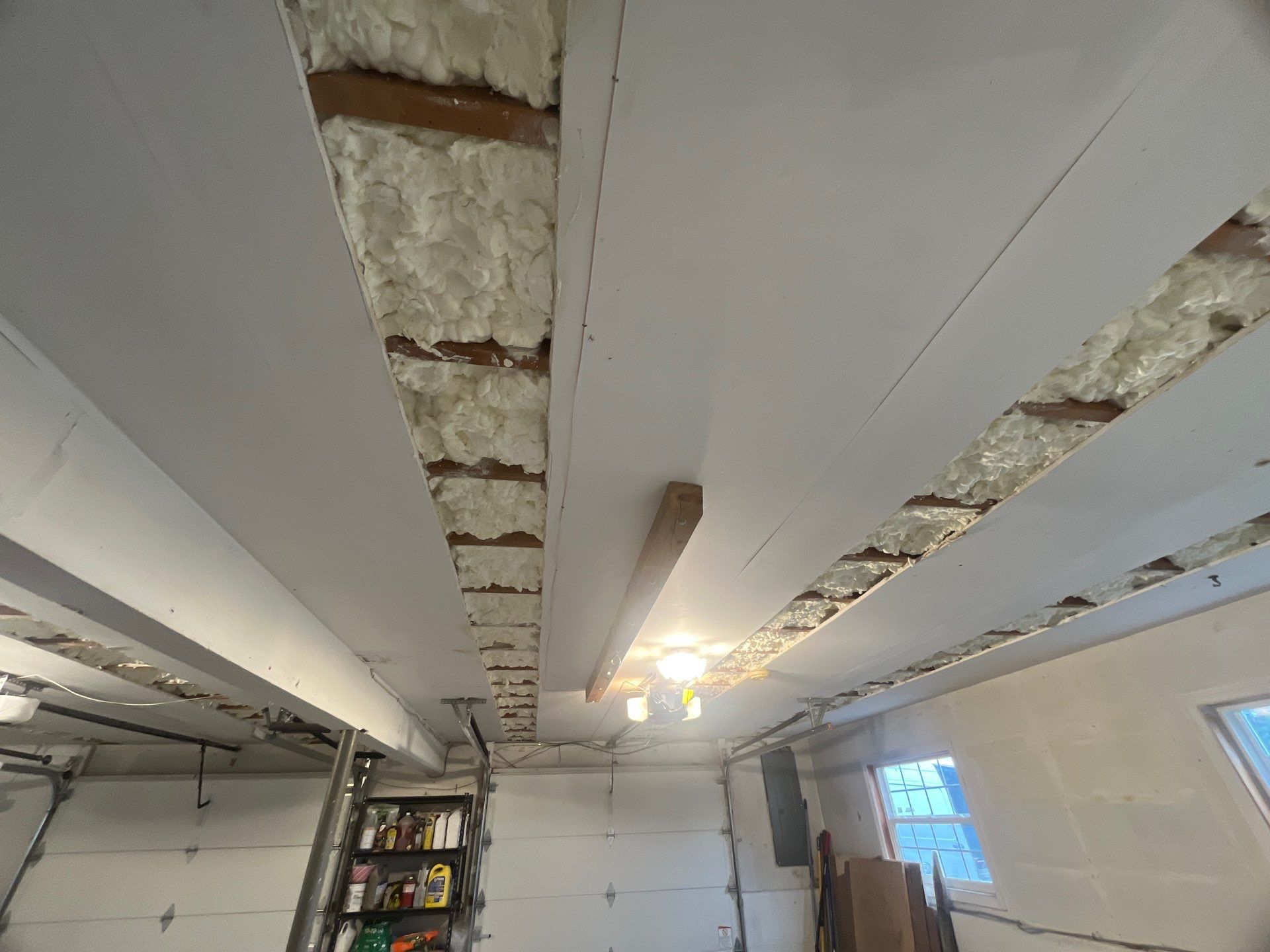 Garage ceiling using open cell spray foam by NYS Foam & Energy