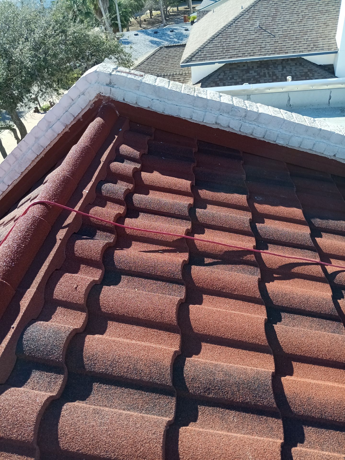 Off with the Tile and on with the TILCOR stone coated metal.  by Bayfront Roofing and Construction