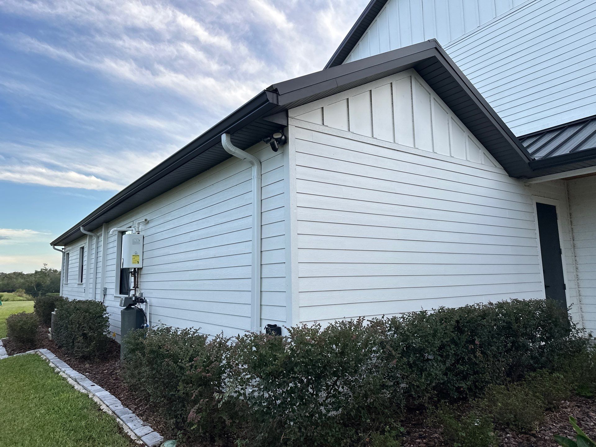 Complete Two-Story House Wash and Driveway Cleaning in Winding River Community, Bradenton, FL by Sunshine AquaWash