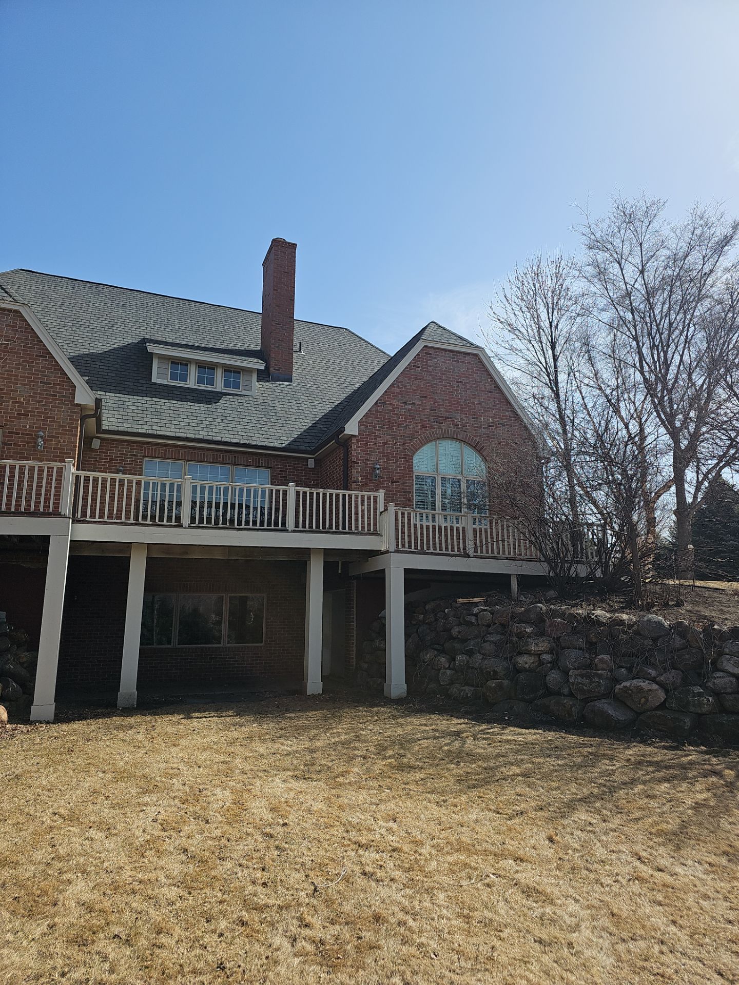 Residential Exterior Brick Painting and Limewash Refresh in Sioux Falls by Select Painting, Coatings & Garage Cabinets