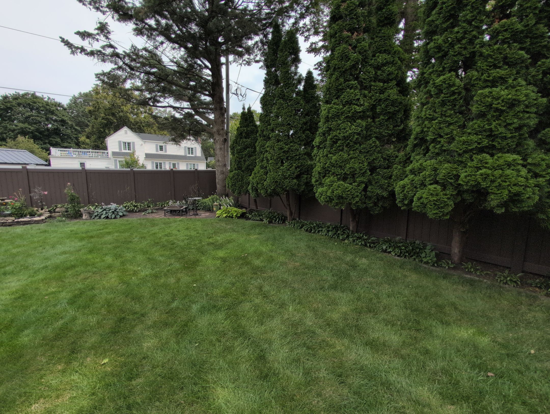 Walnut Vinyl Privacy Fence Installation in Waterloo by Perfect Picket Fence and Stain