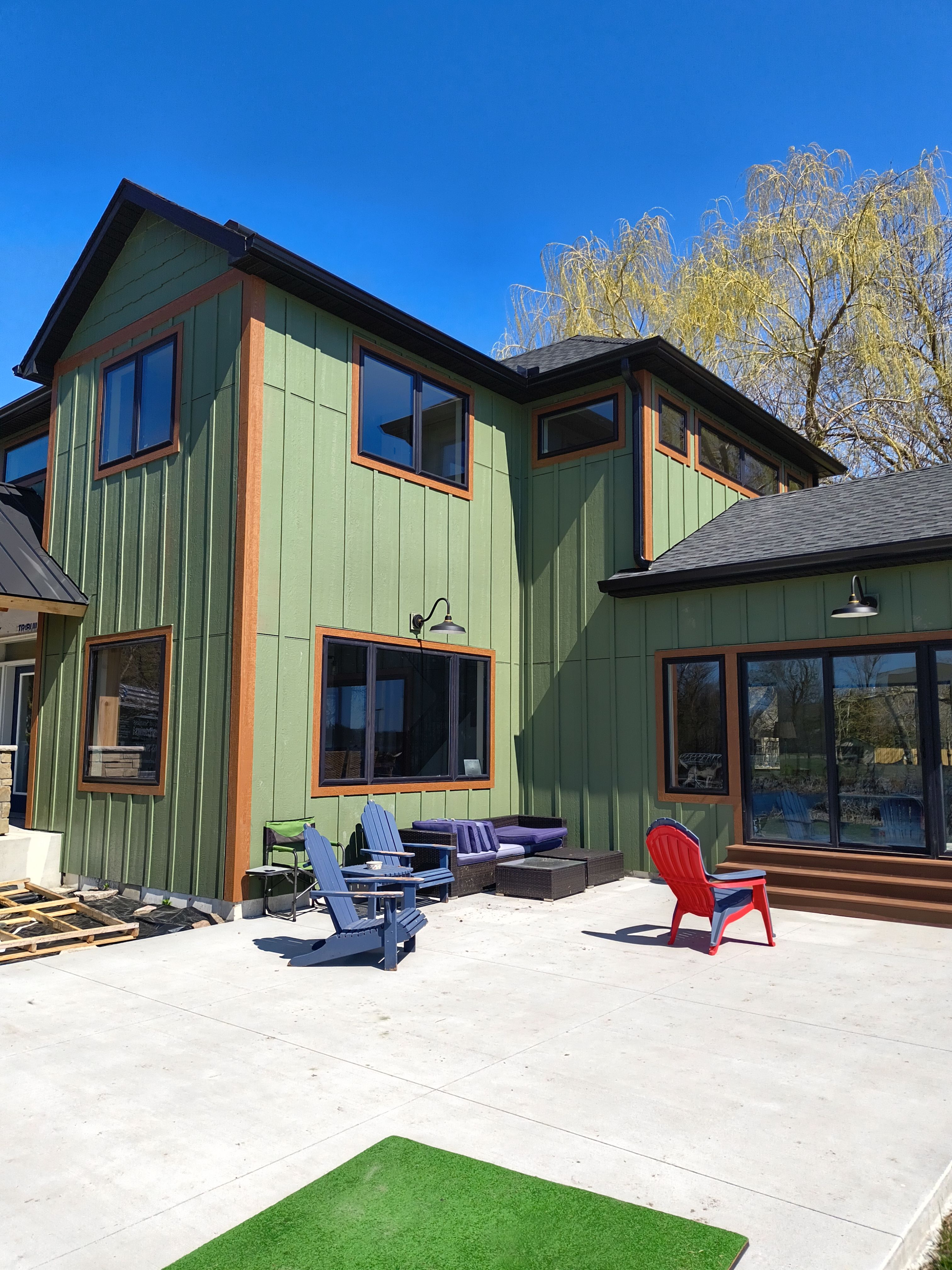 Seamless Gutter Installation in Annandale MN | 6” Black Gutters on Green Home by Next Level Seamless Gutters / Exteriors Inc.