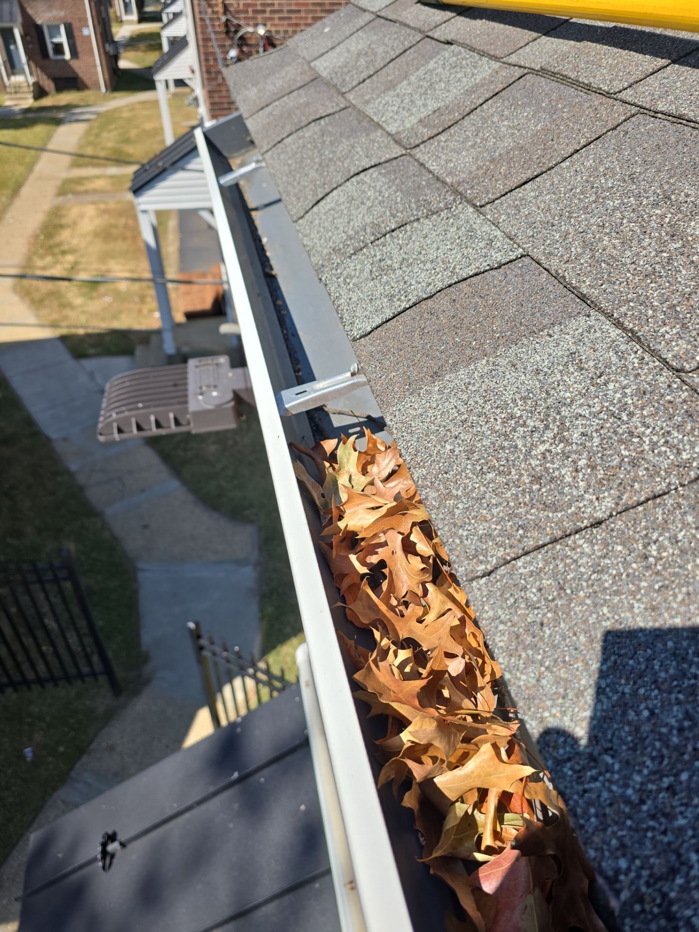 Commercial gutter cleaning Cherry Hill & Camden, NJ before photo with filled gutters