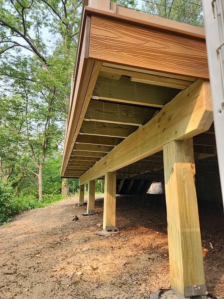 Deck installation using cable railing. by Burke Home Services
