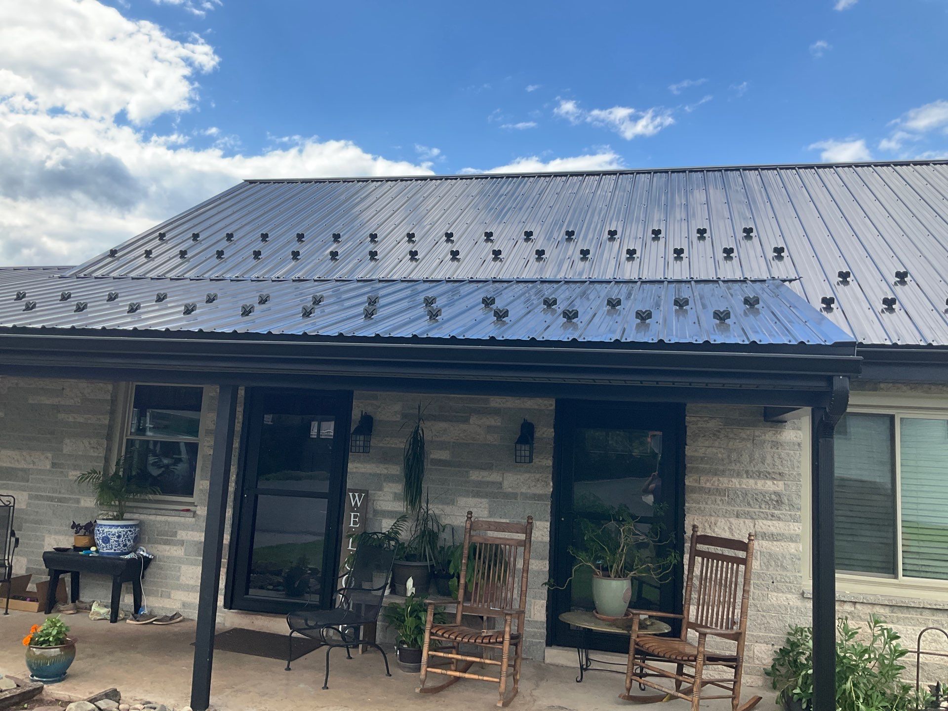 Metal Roofing, Board & Batten Siding, and Entry Door Transformation by Esh Builders