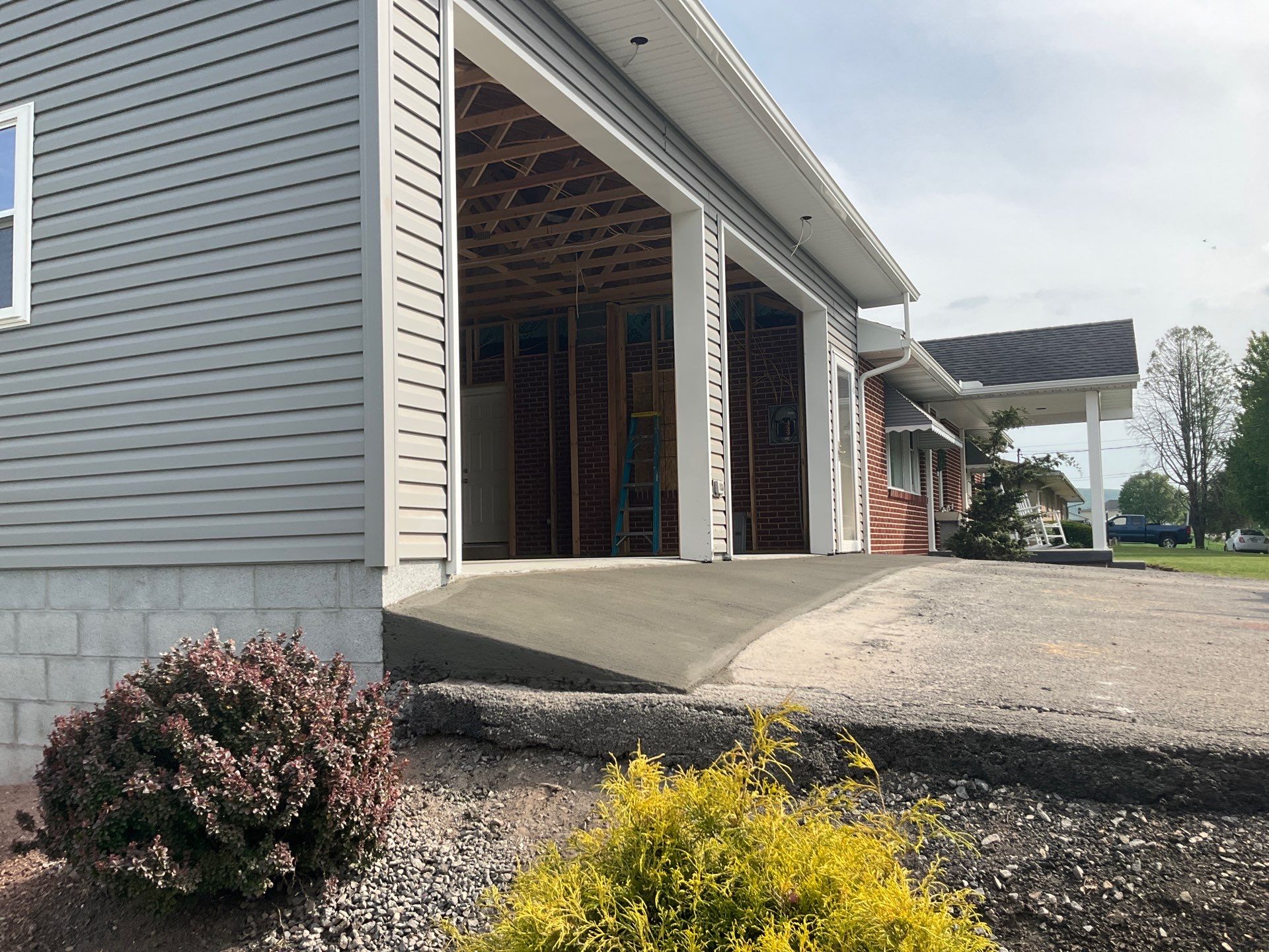 Tower City Residential Addition Featuring Gray Vinyl Siding and Garage by Esh Builders