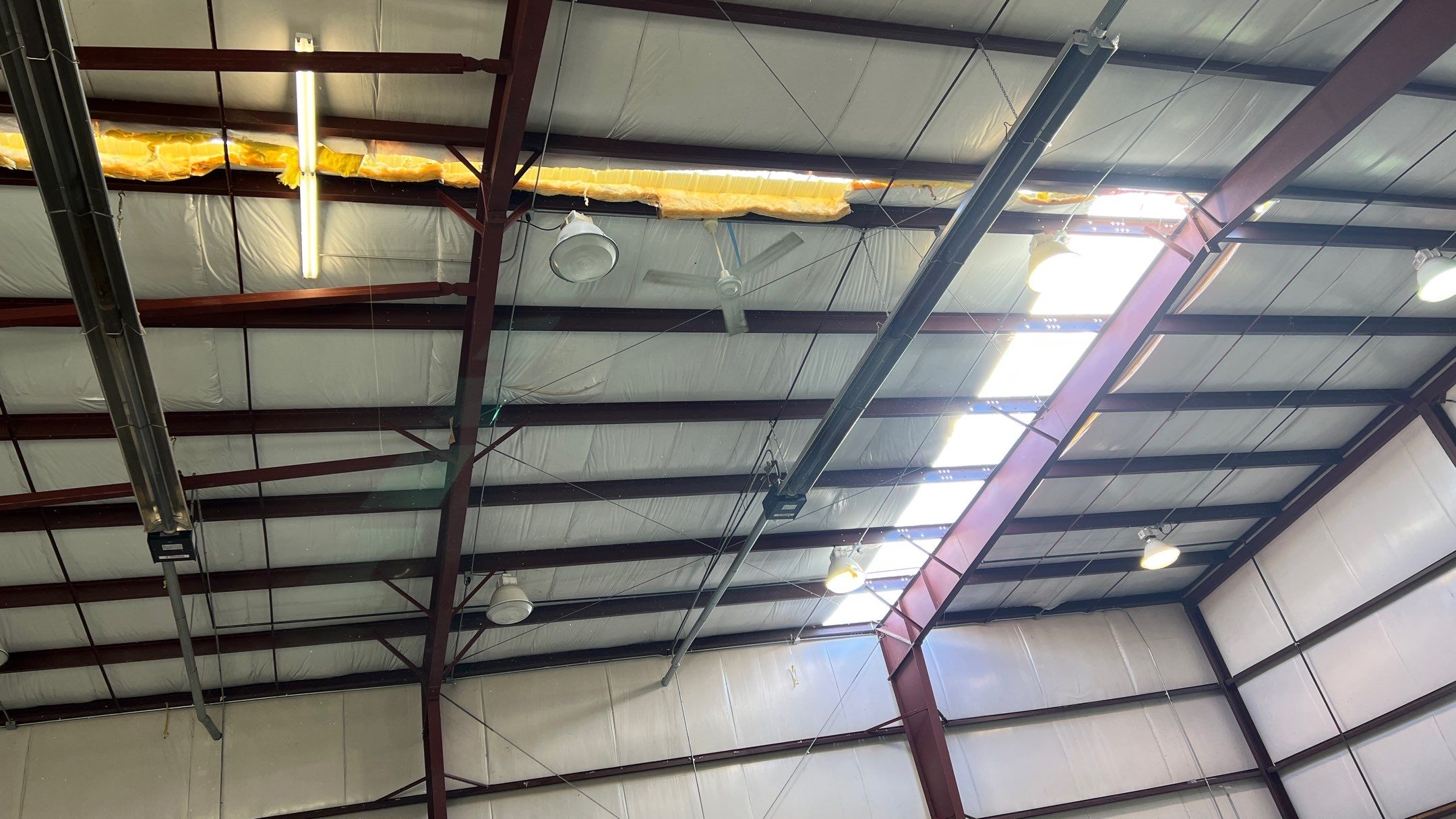 Airport Hanger Metal Roof Replacement and Insulation by Villegas Remodeling, LLC