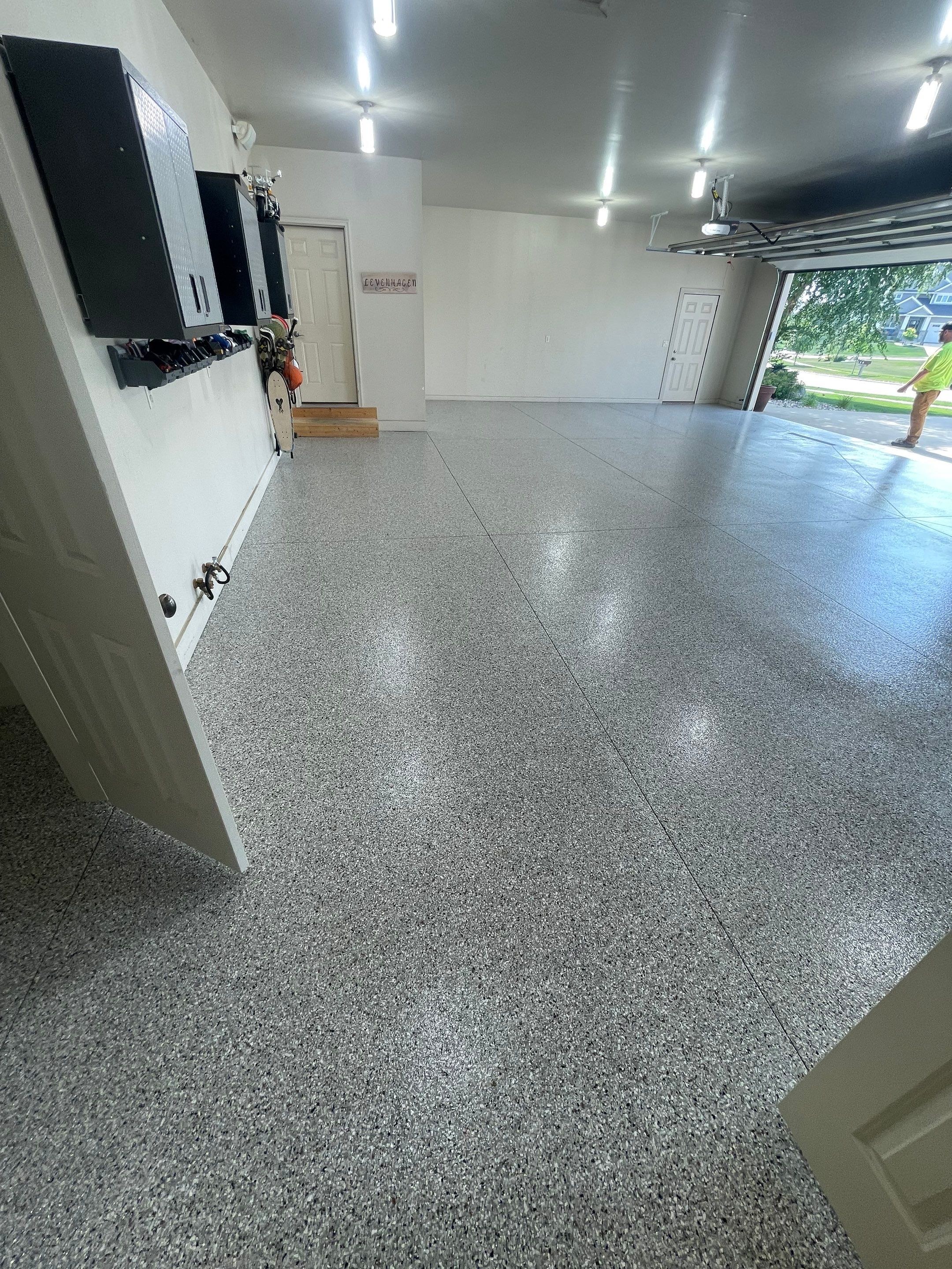 Coyote Flake Garage Floor Coating in Sioux Falls with Trench Drain by Select Painting, Coatings & Garage Cabinets