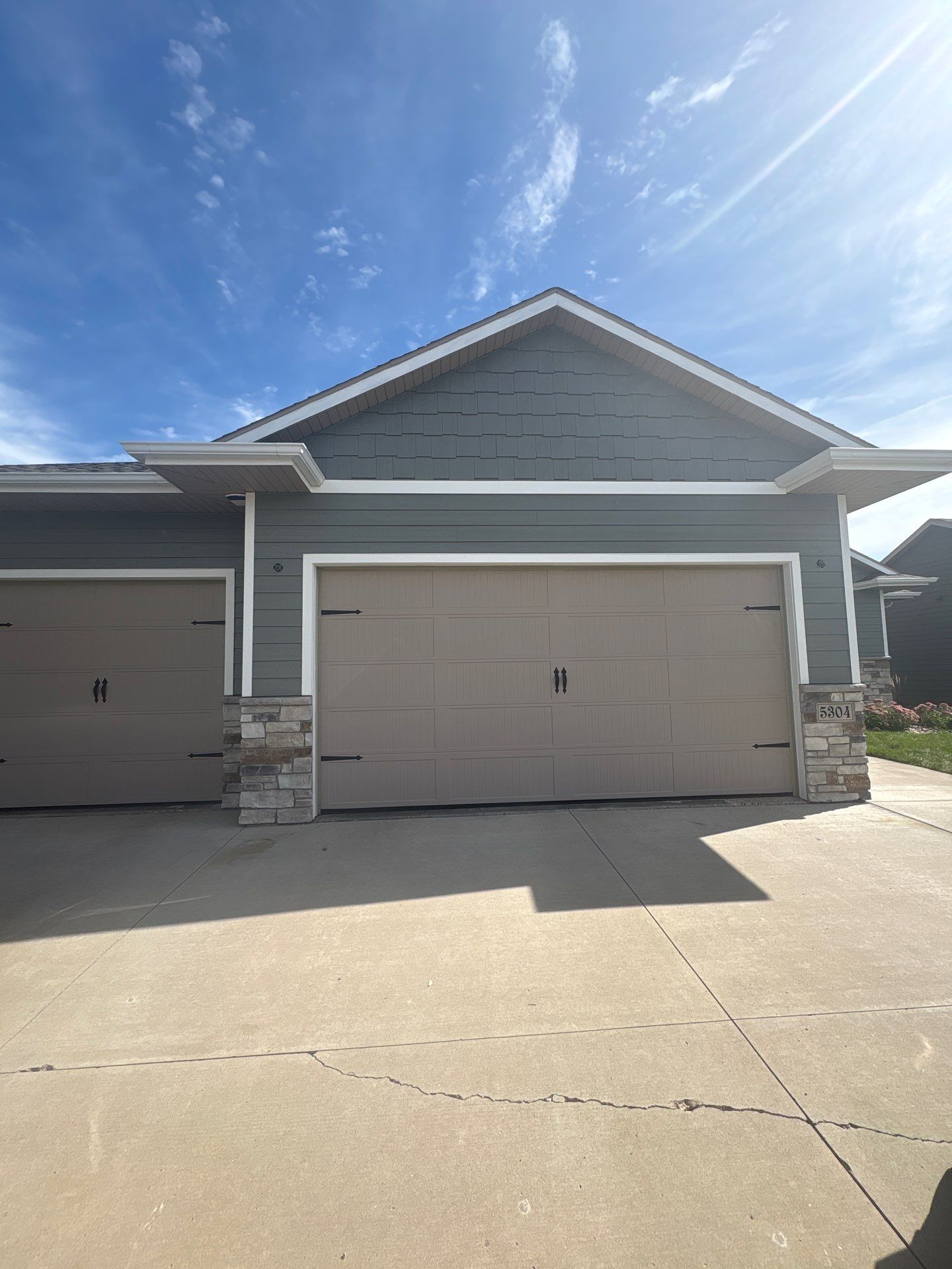 Full Exterior Home Painting on Blue Lap Siding in Sioux Falls by Select Painting, Coatings & Garage Cabinets