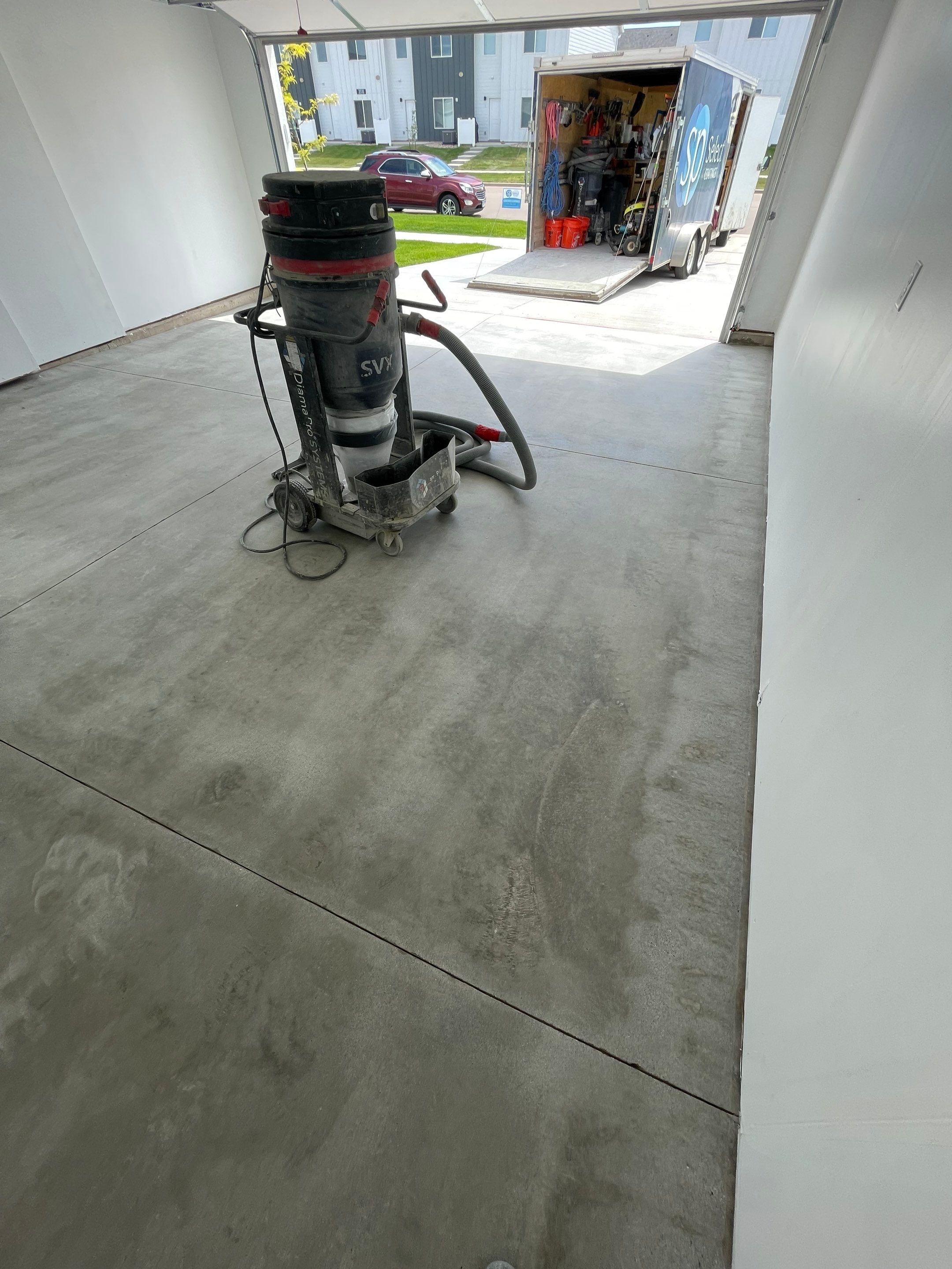 Sioux Falls Garage Floor Transformation with Cabin Fever Decorative Chips by Select Painting, Coatings & Garage Cabinets