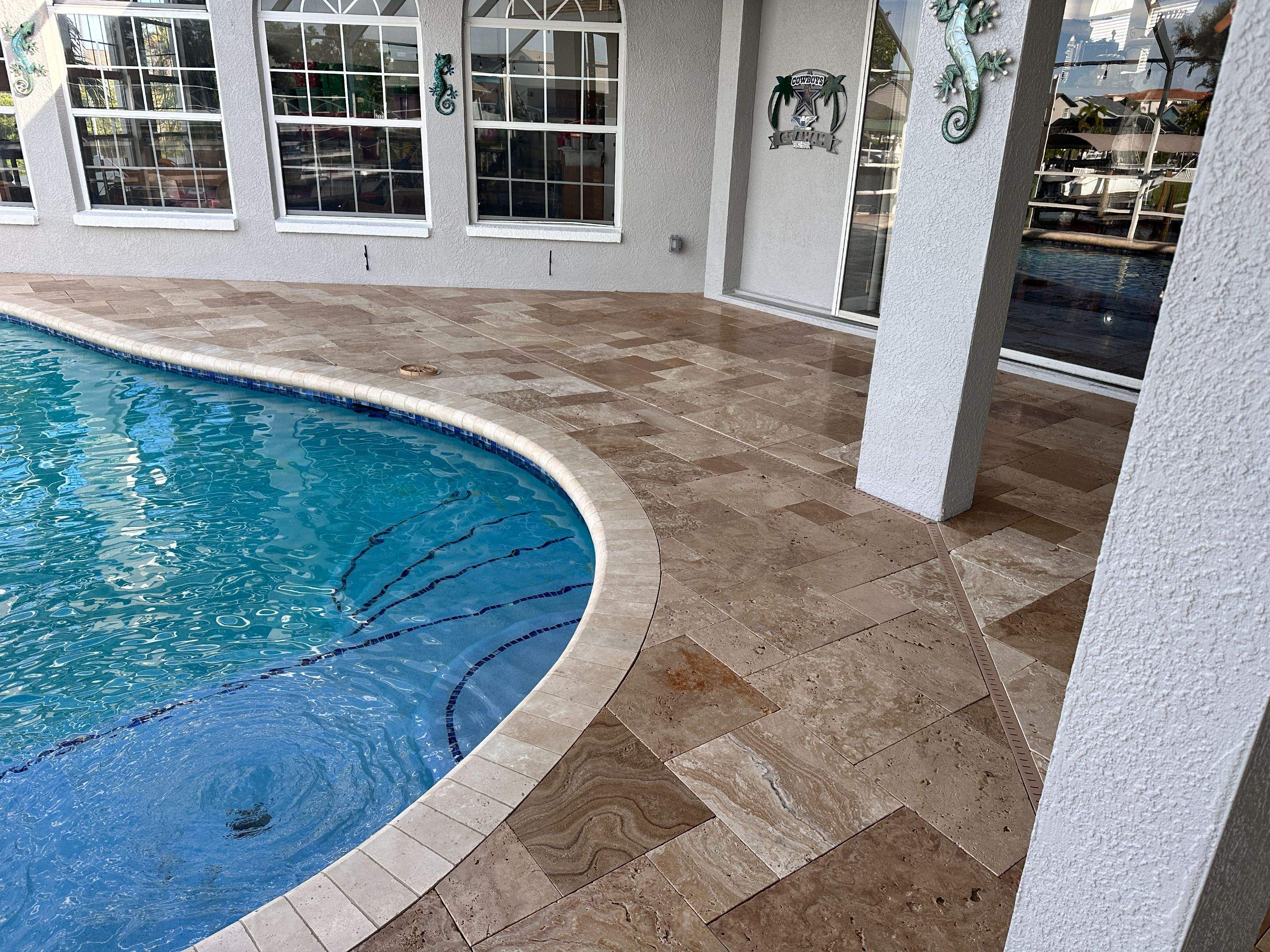Travertine Sealing and Stripping for a Waterfront Pool Deck in Apollo Beach by Supreme Paver Experts