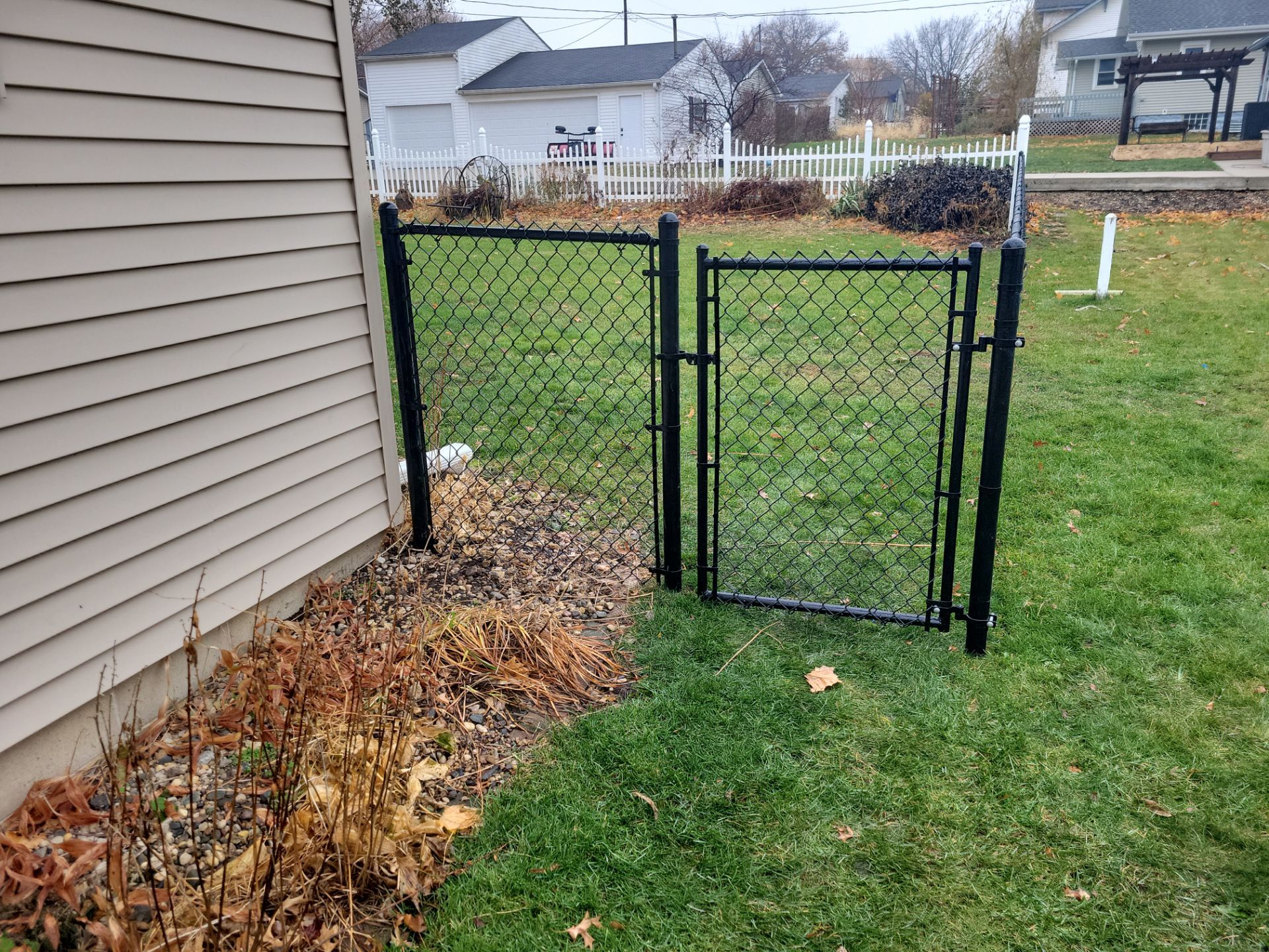 Black Vinyl-Coated Chain Link Fence Installation in Aplington by Perfect Picket Fence and Stain