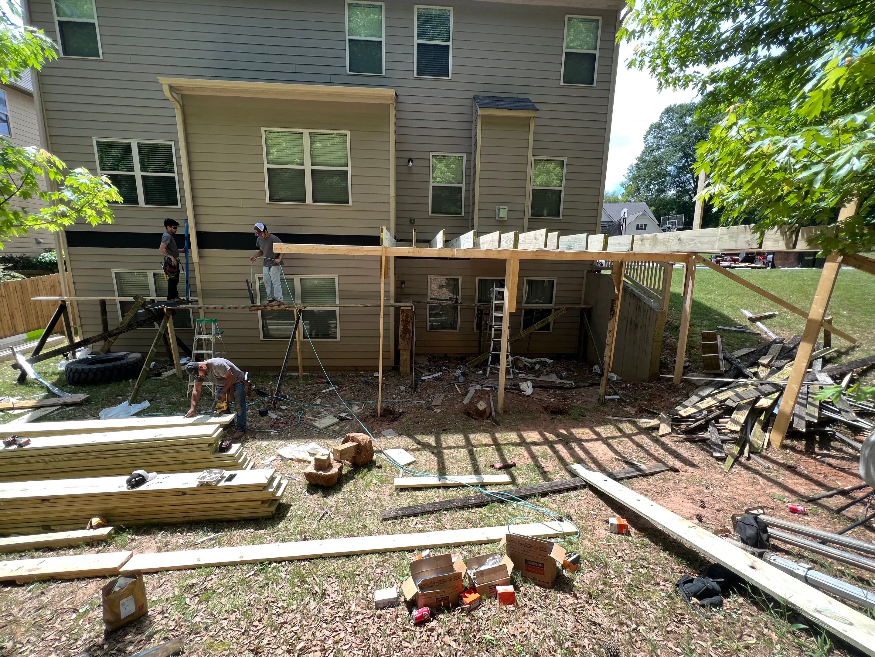 Custom Elevated Deck Replacement with White and Black Railings by Swift Home Renovations