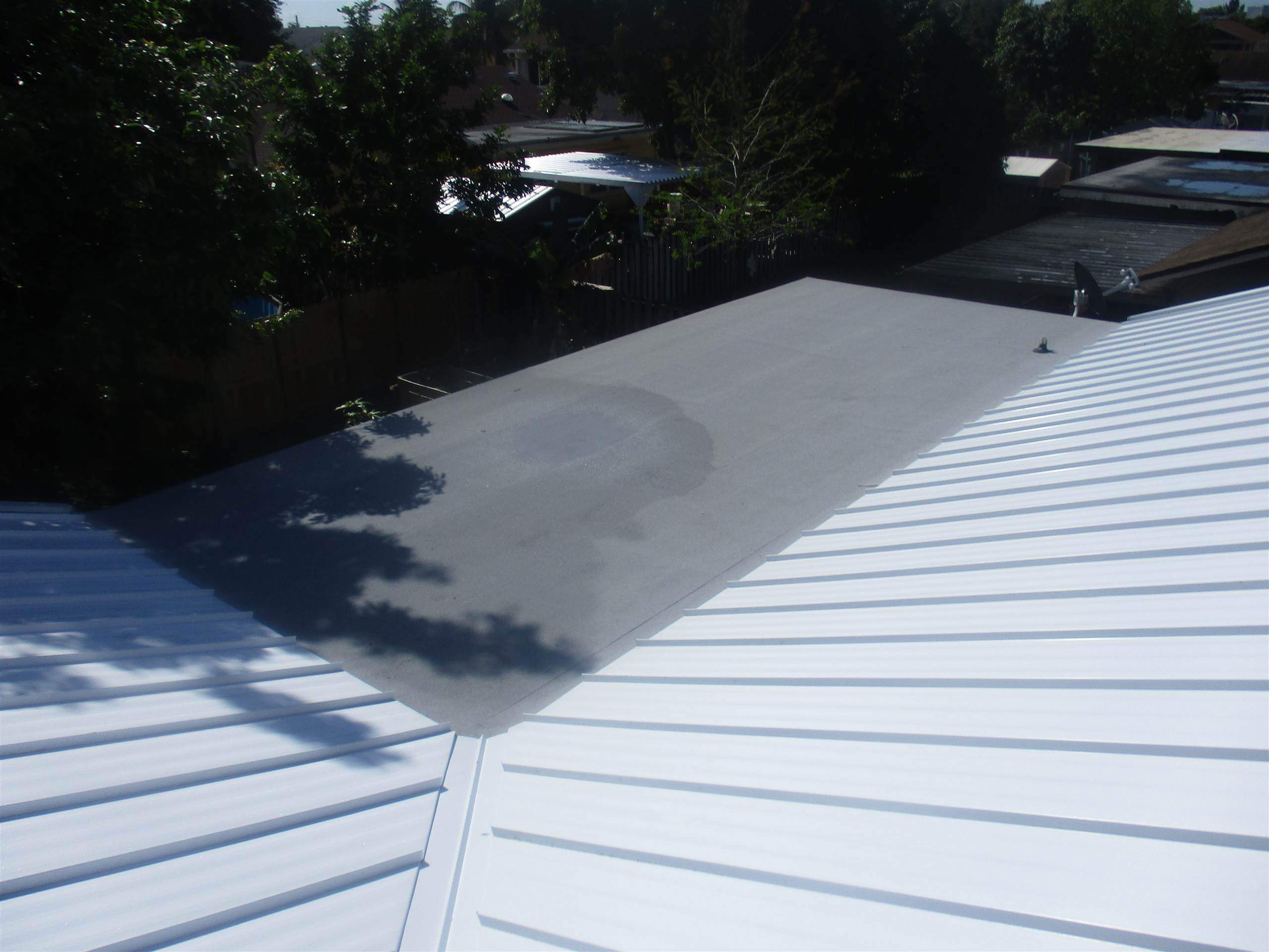Standing Seam Metal & Flat Re-Roof using 1.5" Nail Strip 24ga Solar White Kynar Coated Standing Seam Metal Panels by Morton Roofing, Inc.