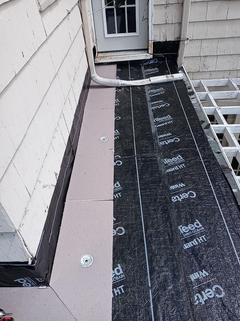 Residential Roofing Installation, Dec-tek walk-out porch roof, siding on garage by Absolute Roofing and Construction