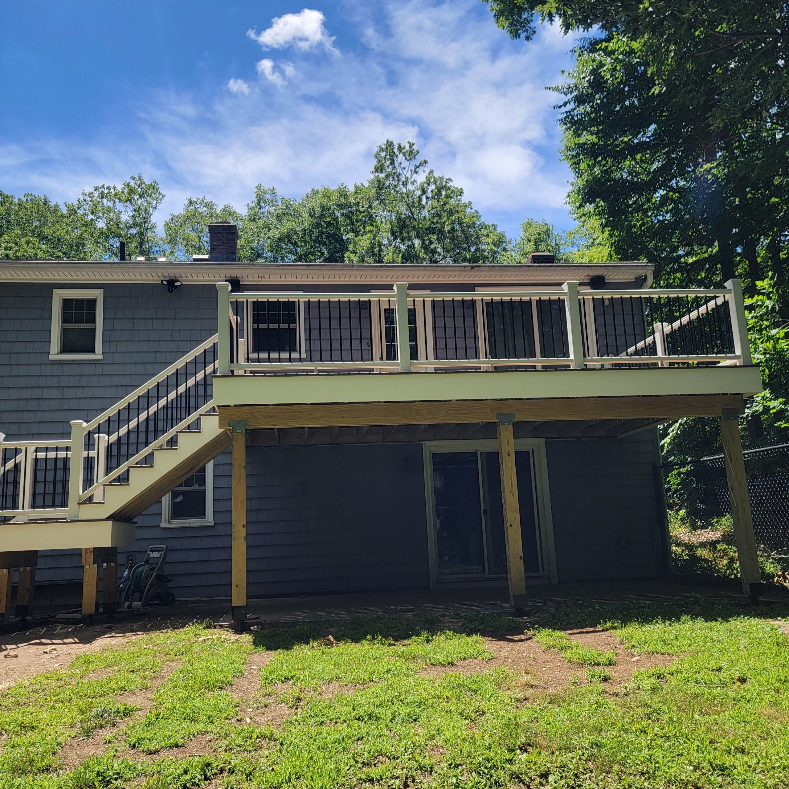 Deck replacement using trex tropical Havana Gold and transcend white railings by DiGiorgi Roofing and Siding Inc