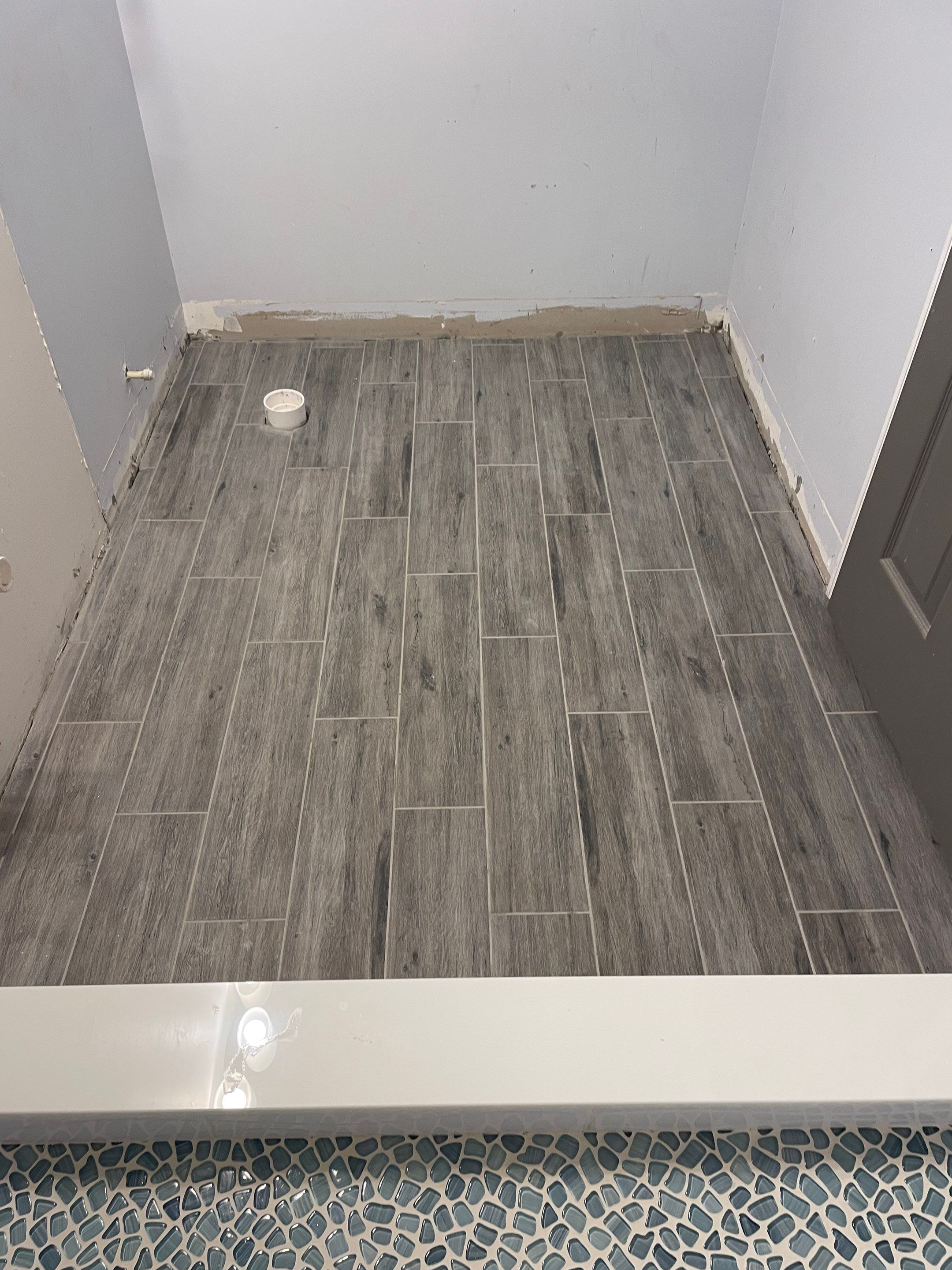 Sleek bathroom shower remodel by Footprints Floors of East Atlanta