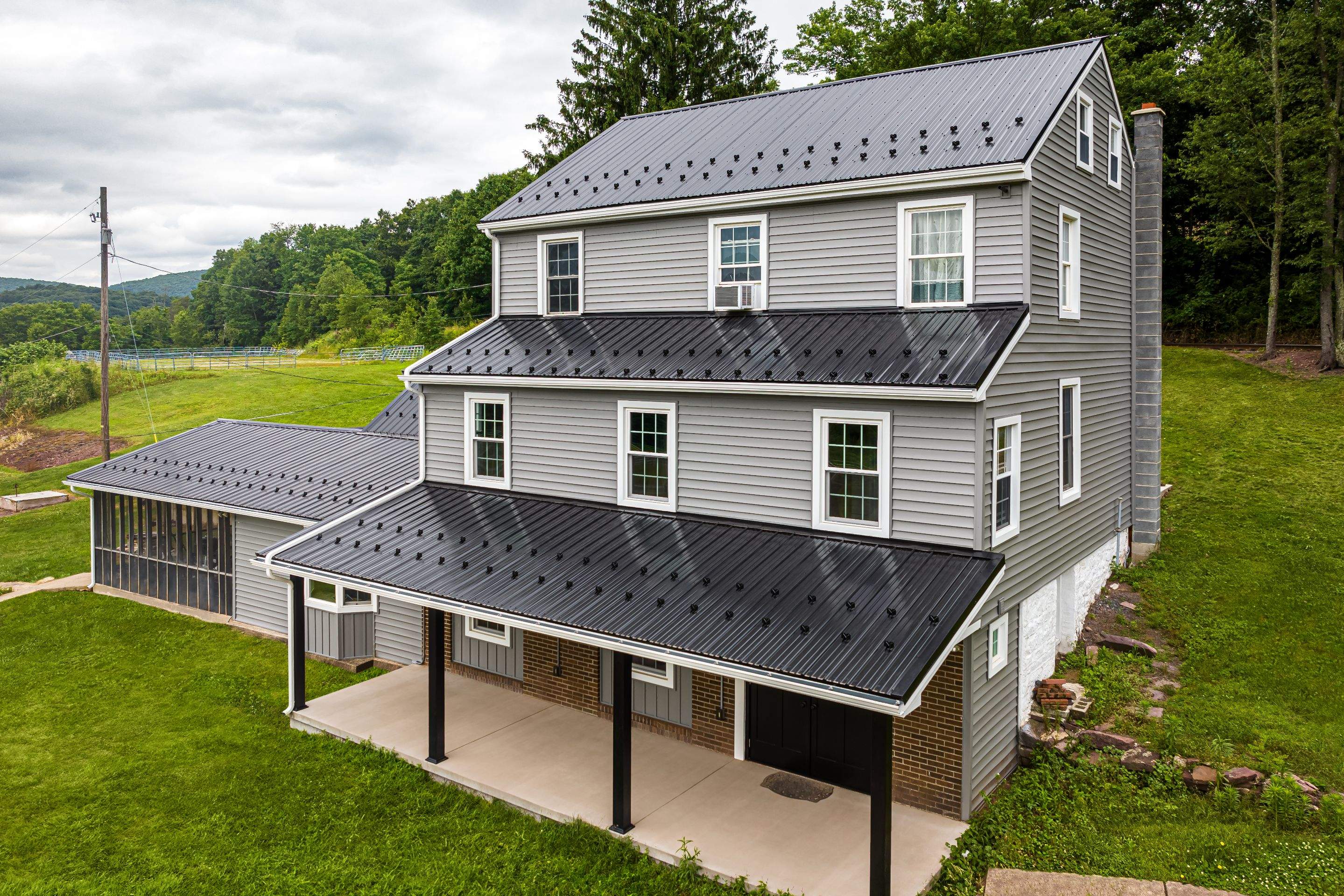 New Metal roof and New siding by Esh Builders