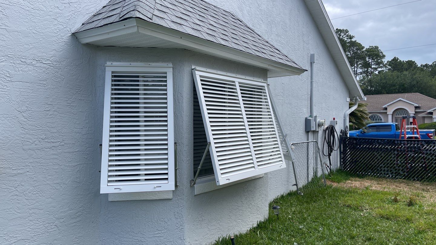 Accordion shutter and Bahama with front slide rod by Smart Guard Shutters
