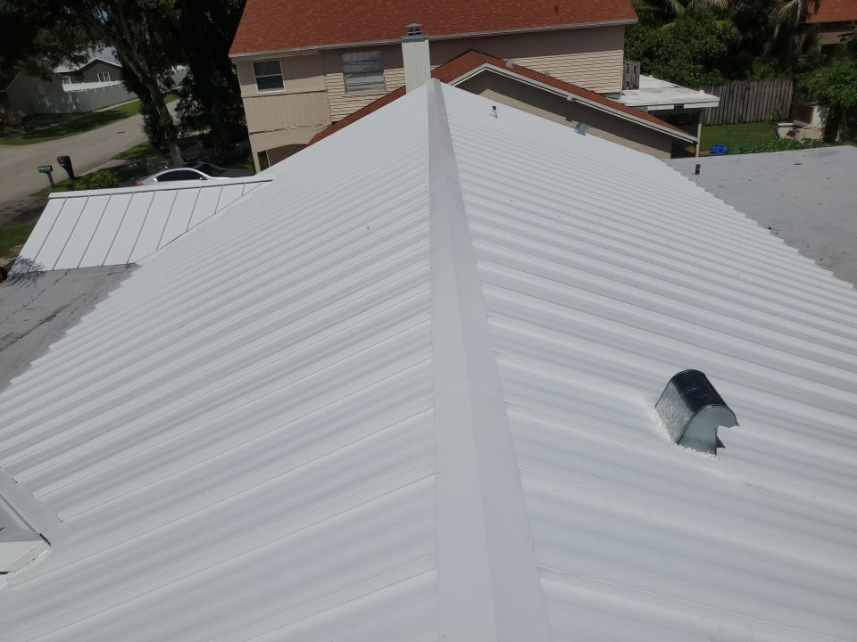 Residential Roofing Installation using 1.5" Nail Strip 24ga Solar White Kynar Coated Standing Seam Metal Panels by Morton Roofing, Inc.