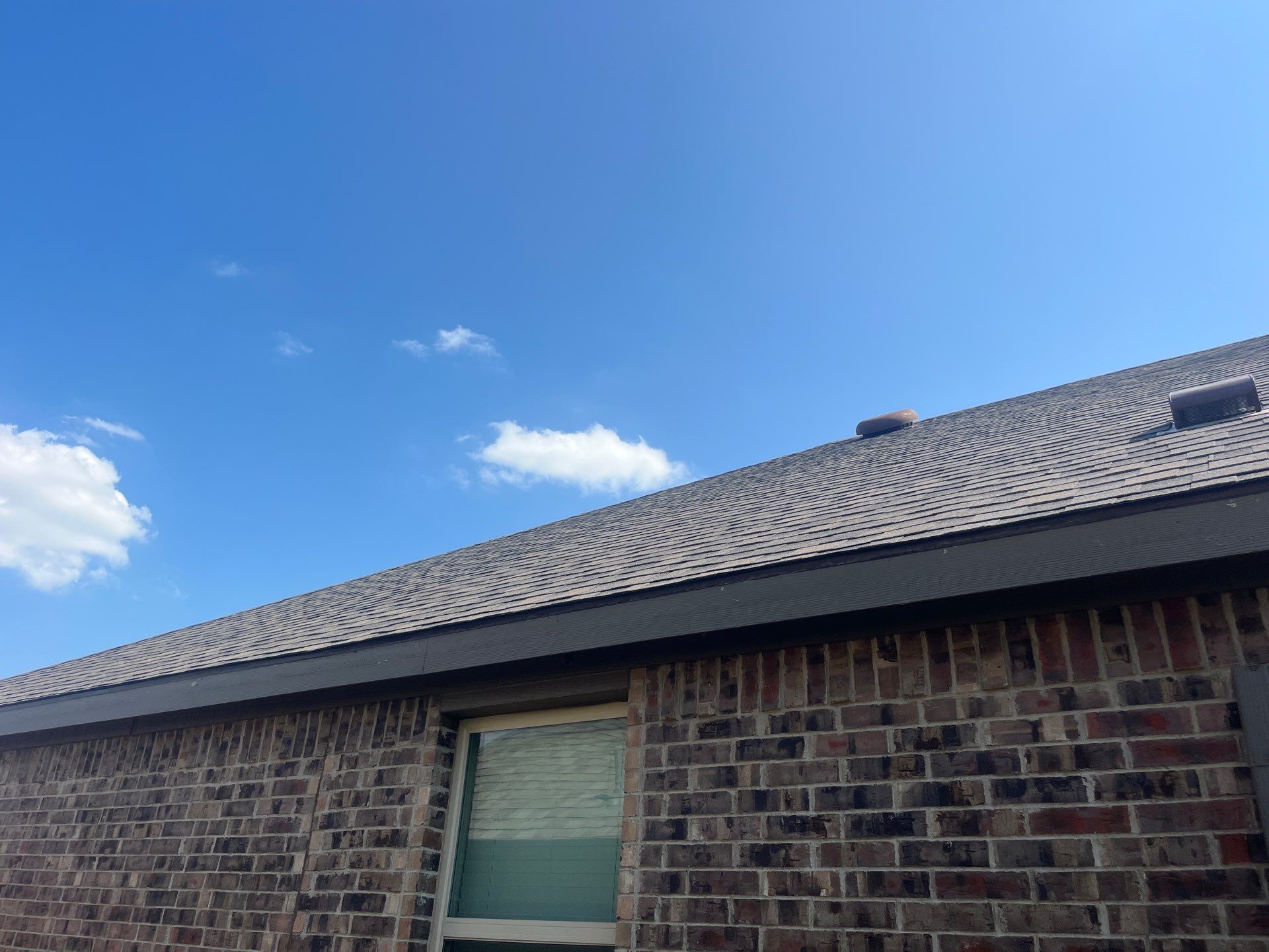 Medium brown brick with IKO Driftshake by Tejas Roofworks + Restoration
