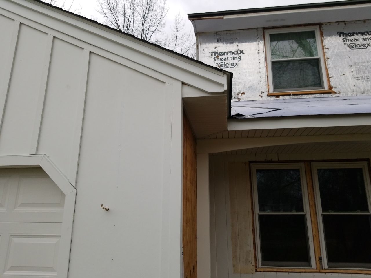 James Hardie Siding  using James Hardie Board and Batten, White by Absolute Roofing and Construction