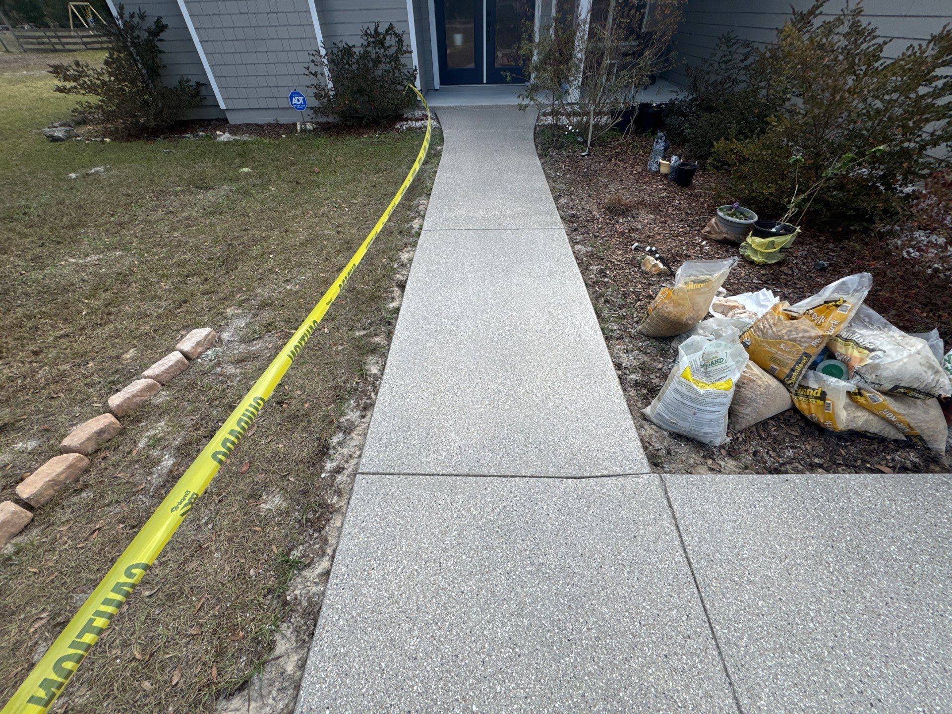 Patio and Sidewalk in Fort White, FL (Patio in Mediterranean, Sidewalk in Claystone Custom Hybrid) by Cross Creek Concrete Coatings