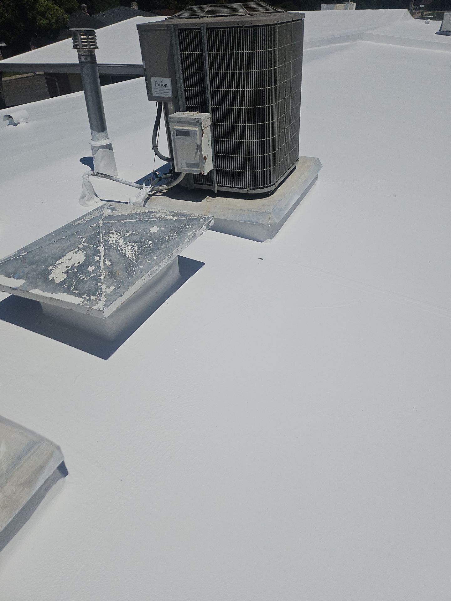 Single-ply restoration system using Benchmark/PUMA XL coatings over TPO single-ply roofing by Straight Edge Roofing Inc