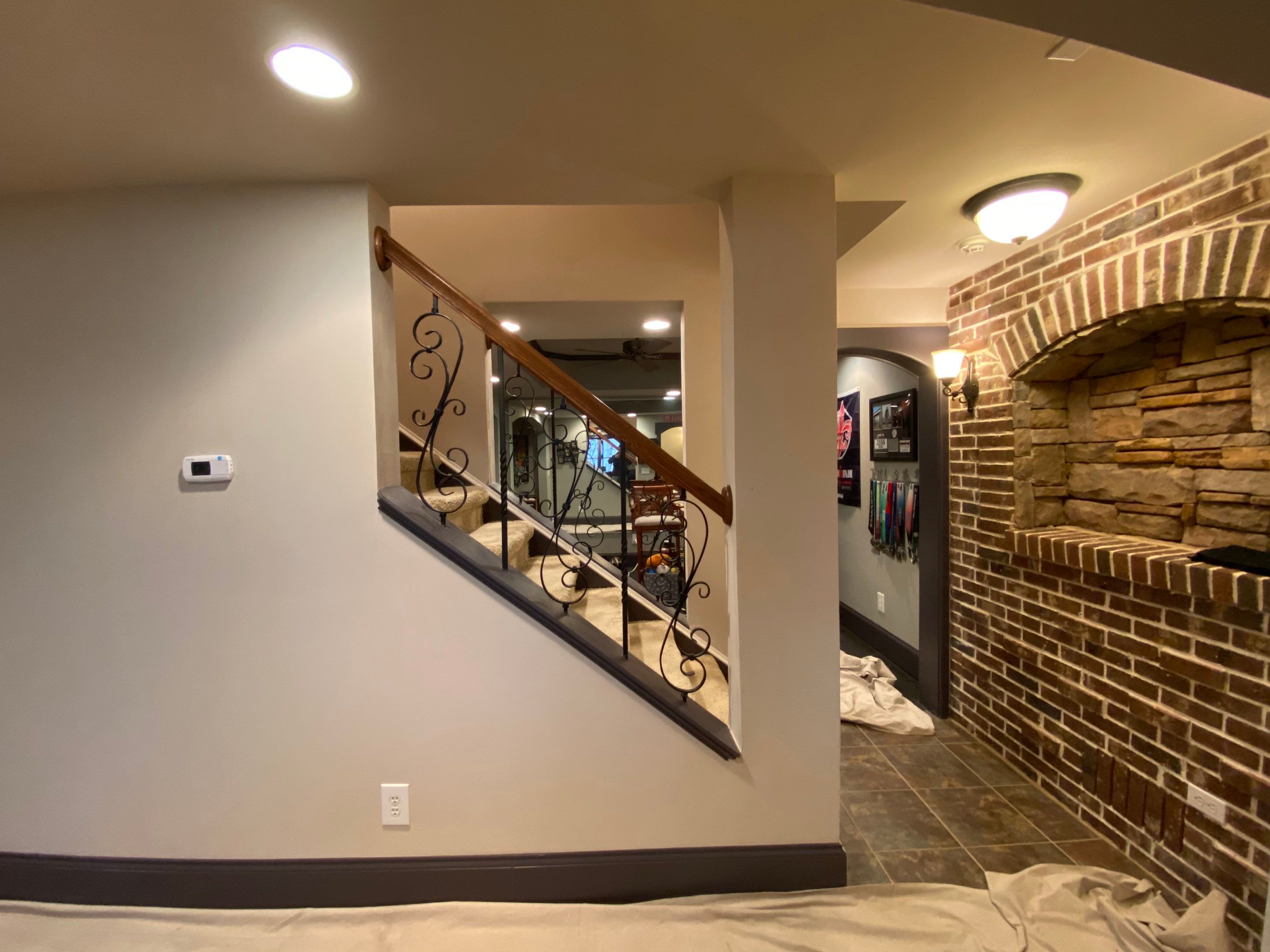 Finished Basement Renovation with Custom Shiplap and Modernized Wood Railings by Swift Home Renovations 