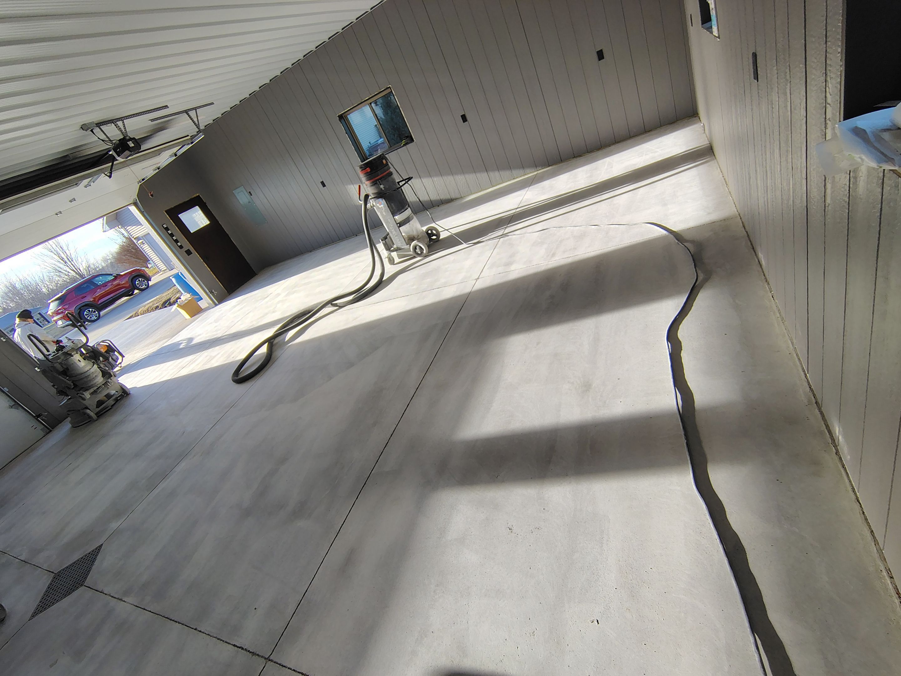 Speckled Epoxy Floor Coating for Large Shop in Rock Valley by Select Painting, Coatings & Garage Cabinets