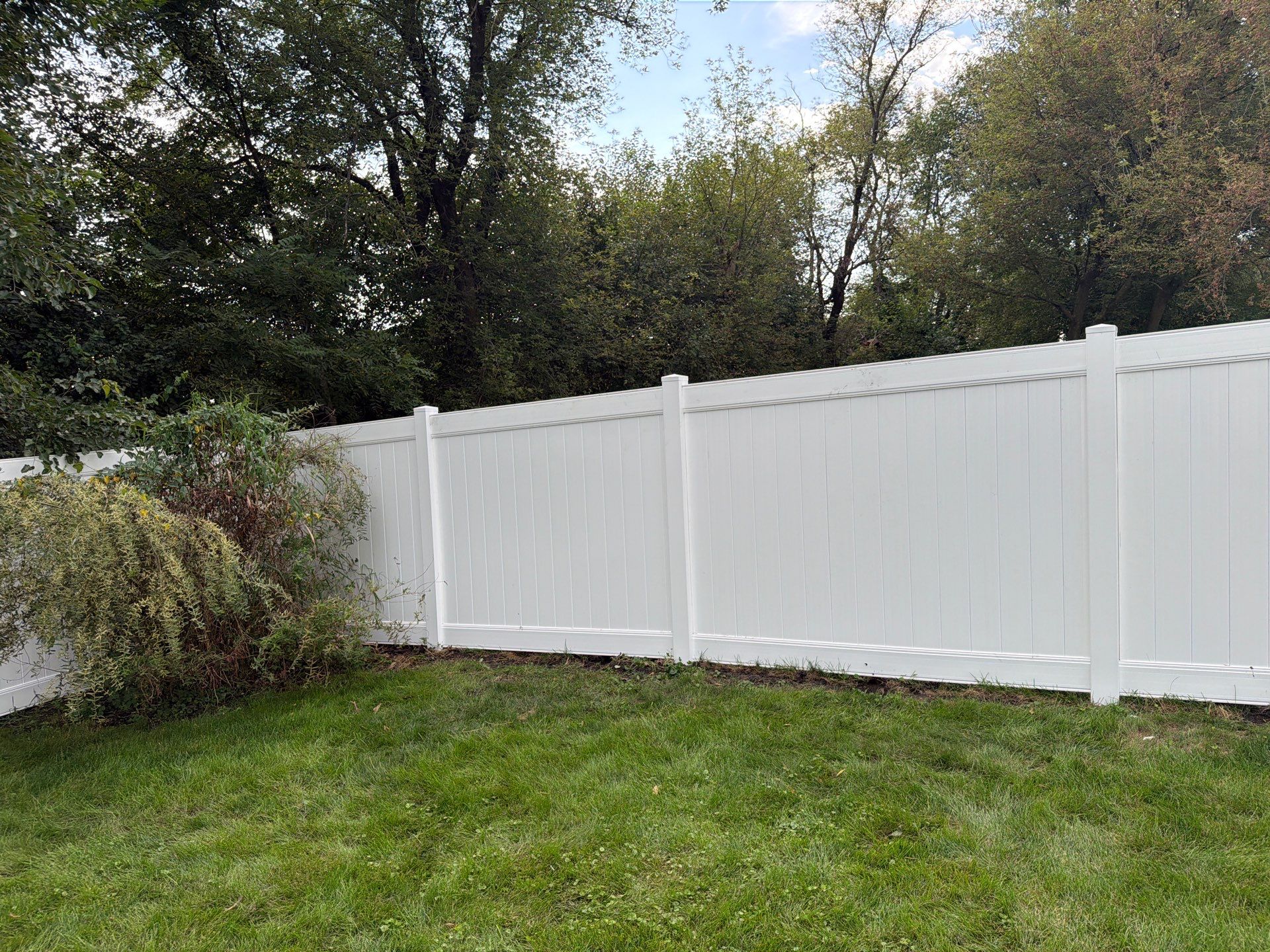 White Vinyl Privacy Fence Installation in Raymond, IA by Perfect Picket Fence and Stain