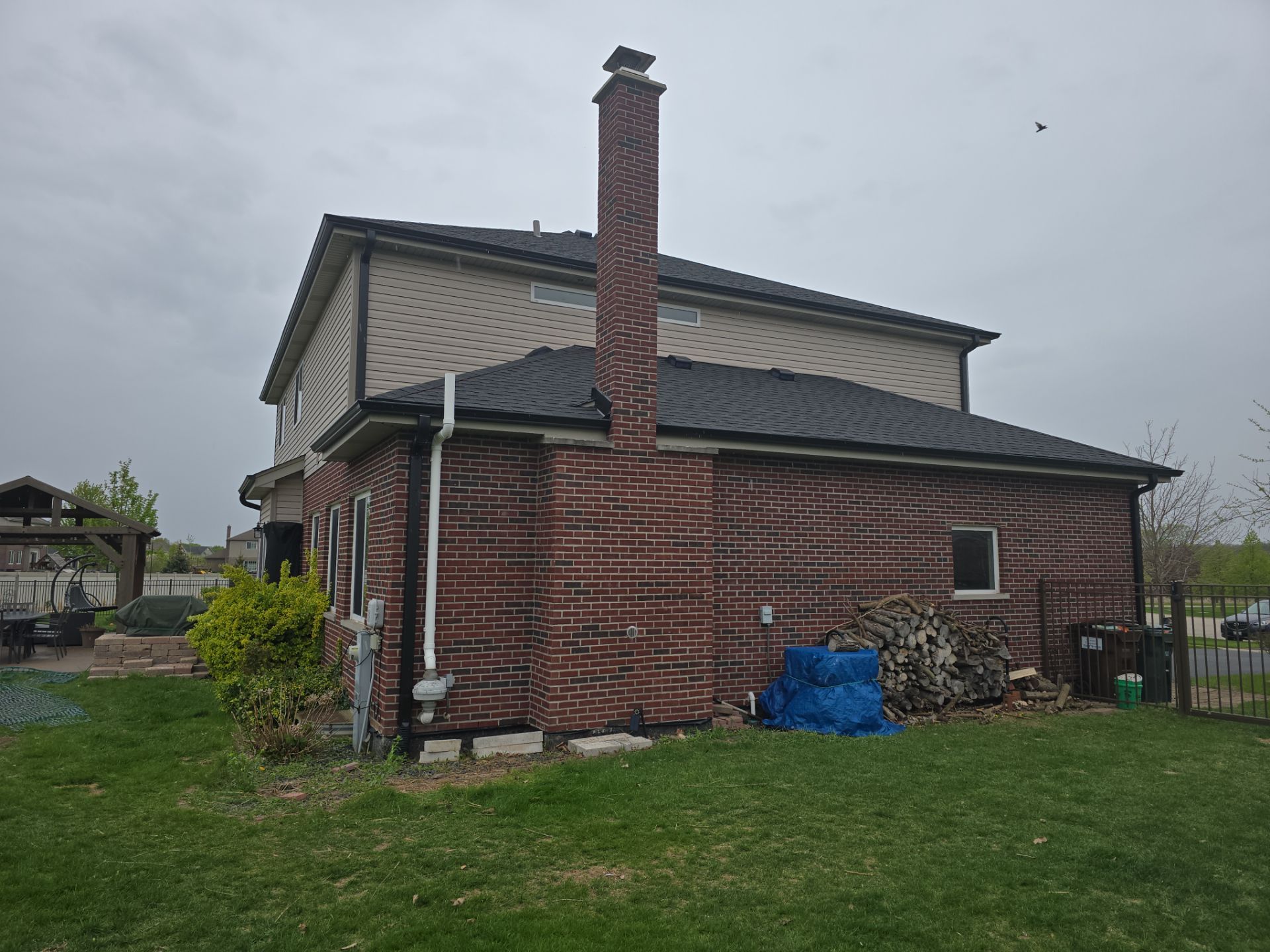 New black gutters and roof by Optimal Home Improvement 