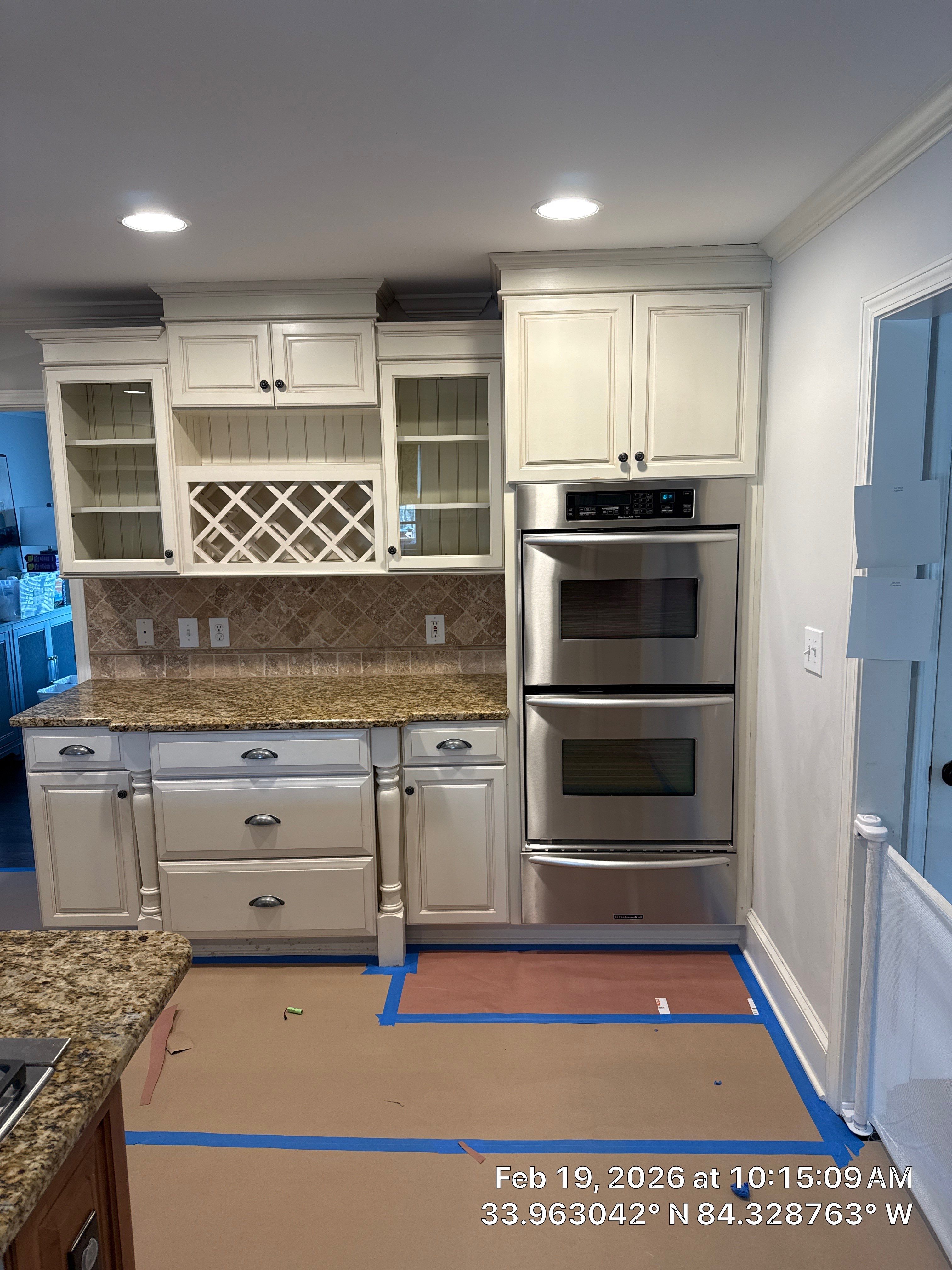 Kitchen Remodel in Dunwoody Featuring White Cabinetry and Blue Island by Heart & Home Kitchen & Bath Remodeling LLC