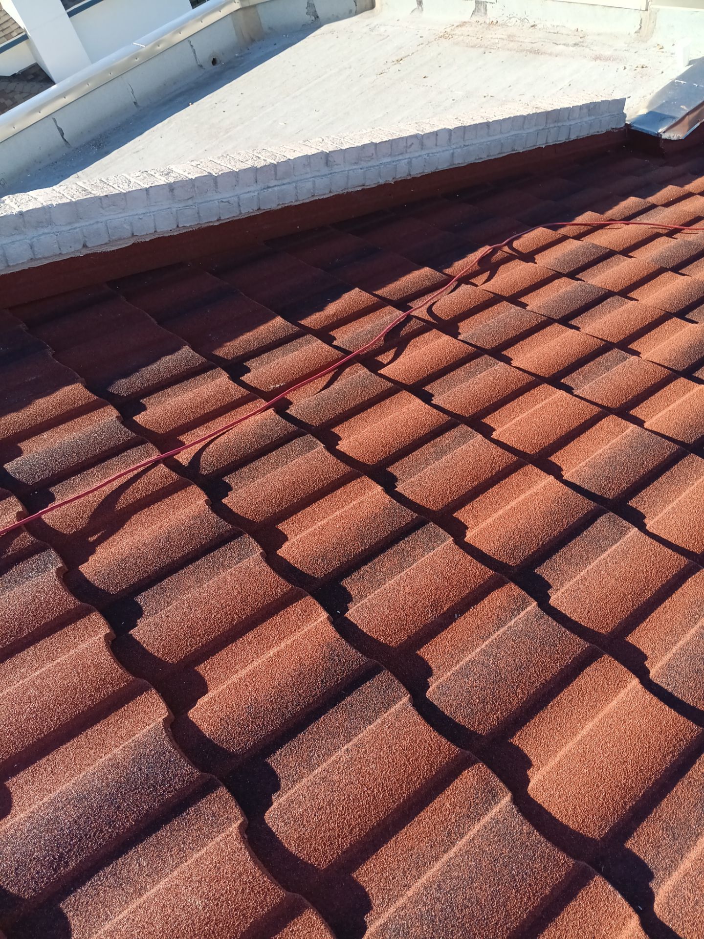 Off with the Tile and on with the TILCOR stone coated metal.  by Bayfront Roofing and Construction