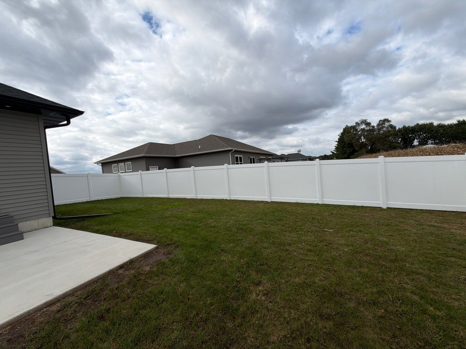 Residential White Vinyl Privacy Fence Installation in Janesville by Perfect Picket Fence and Stain