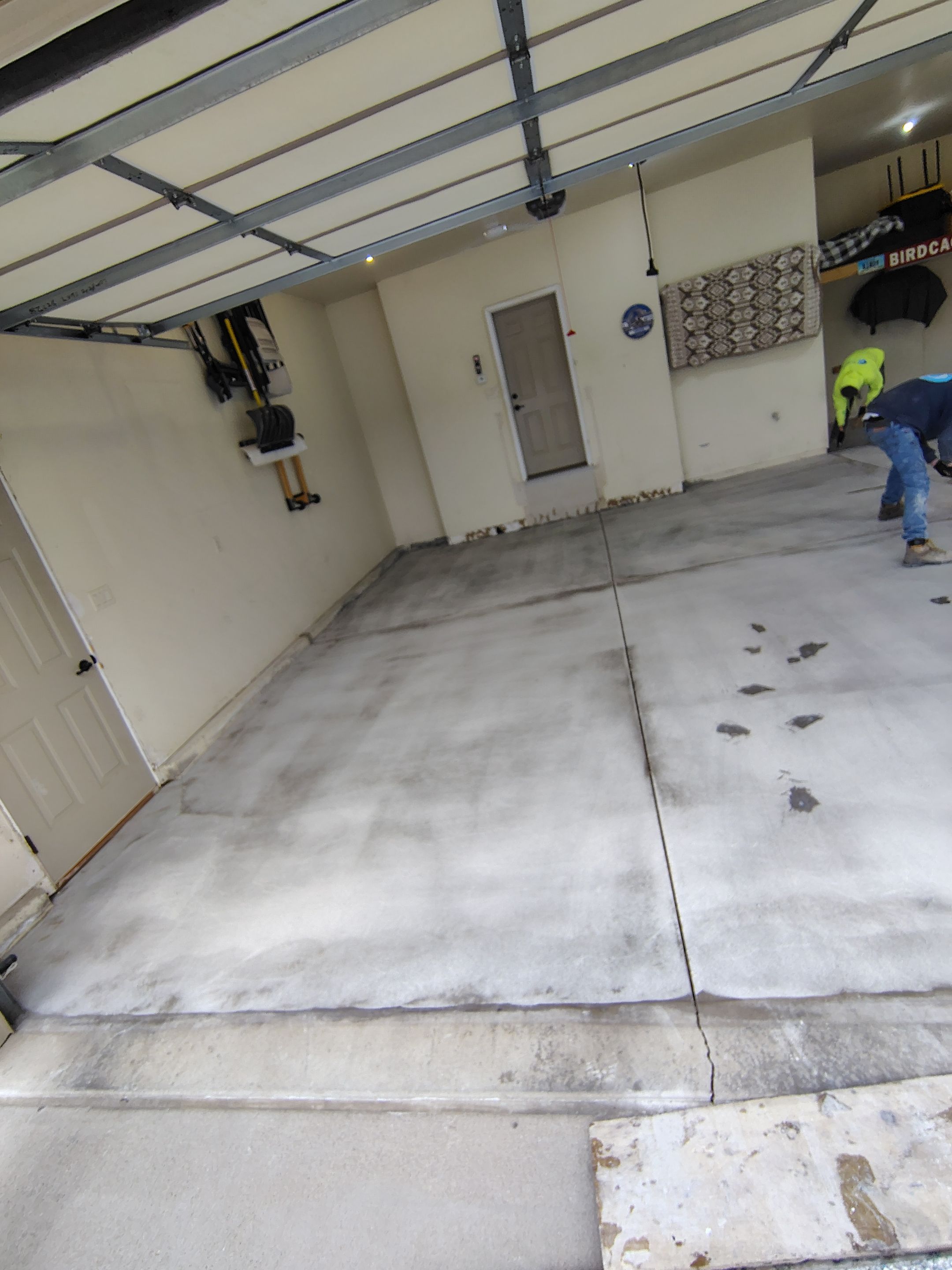 Sioux Falls Garage Floor Repair and Speckled Epoxy Coating Installation by Select Painting, Coatings & Garage Cabinets