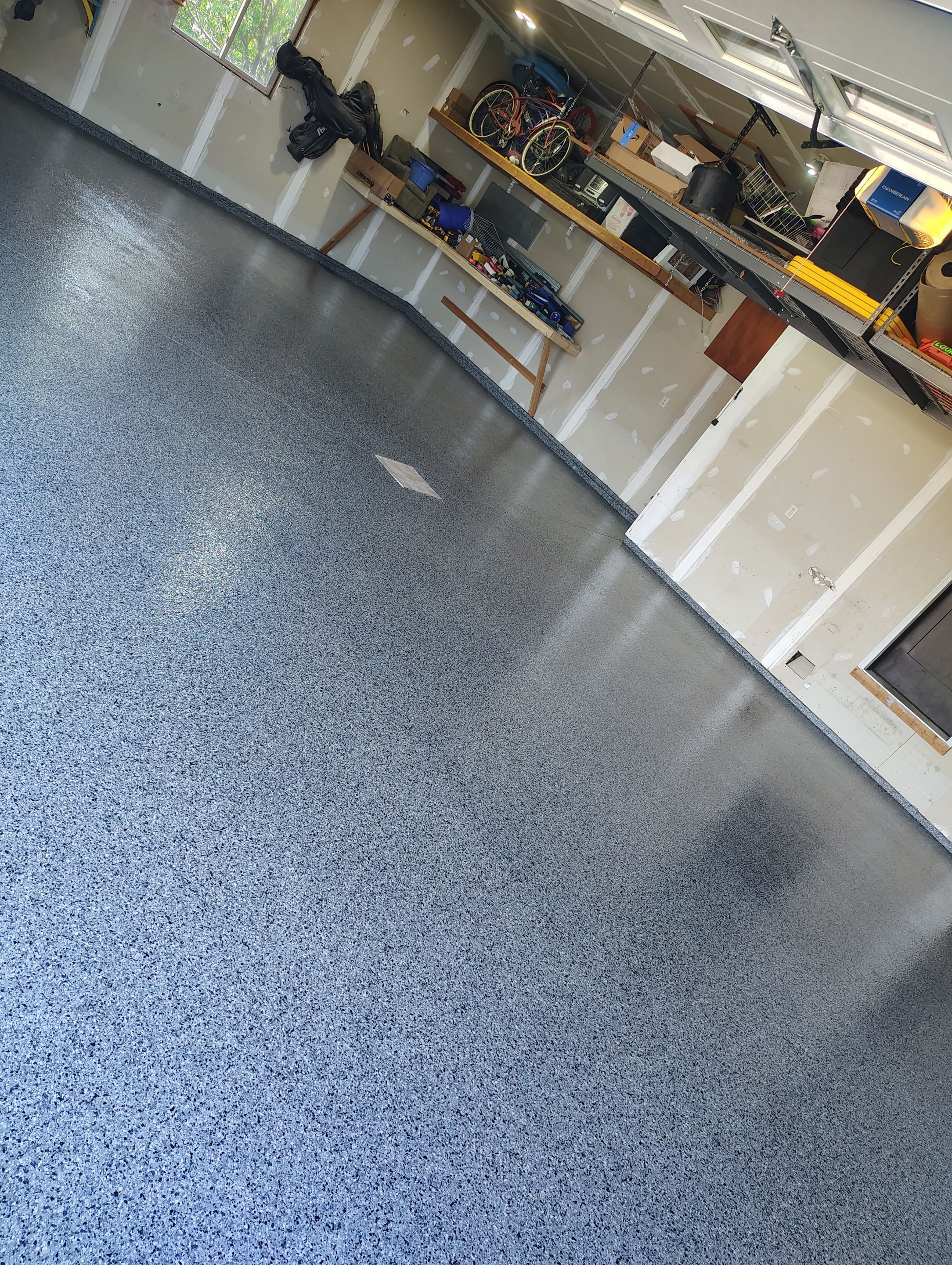 Sioux Falls Garage Concrete Grinding and Nightfall Decorative Chip Coating by Select Painting, Coatings & Garage Cabinets