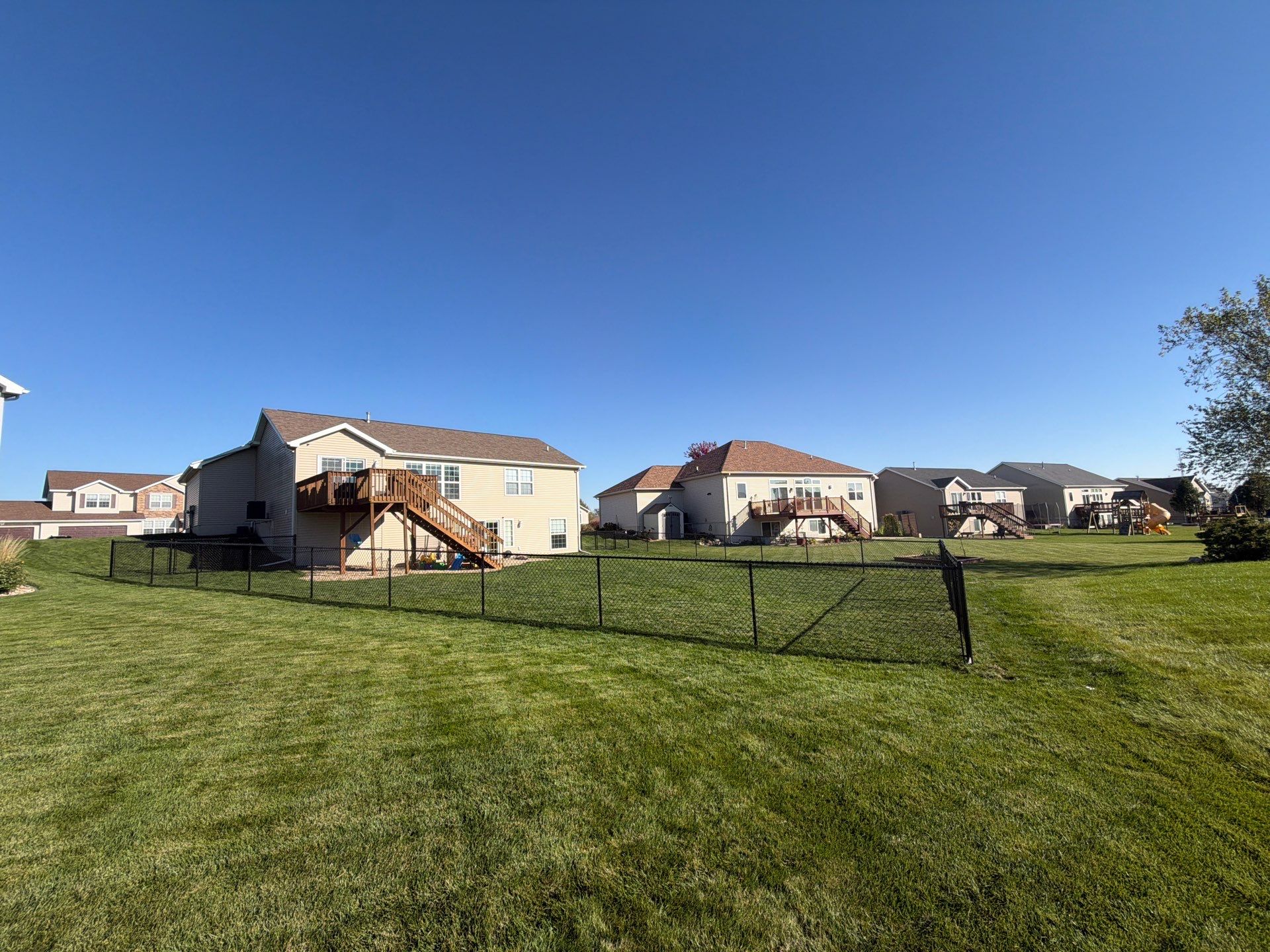 Black Vinyl-Coated Chain Link Fence Installation in Cedar Falls by Perfect Picket Fence and Stain