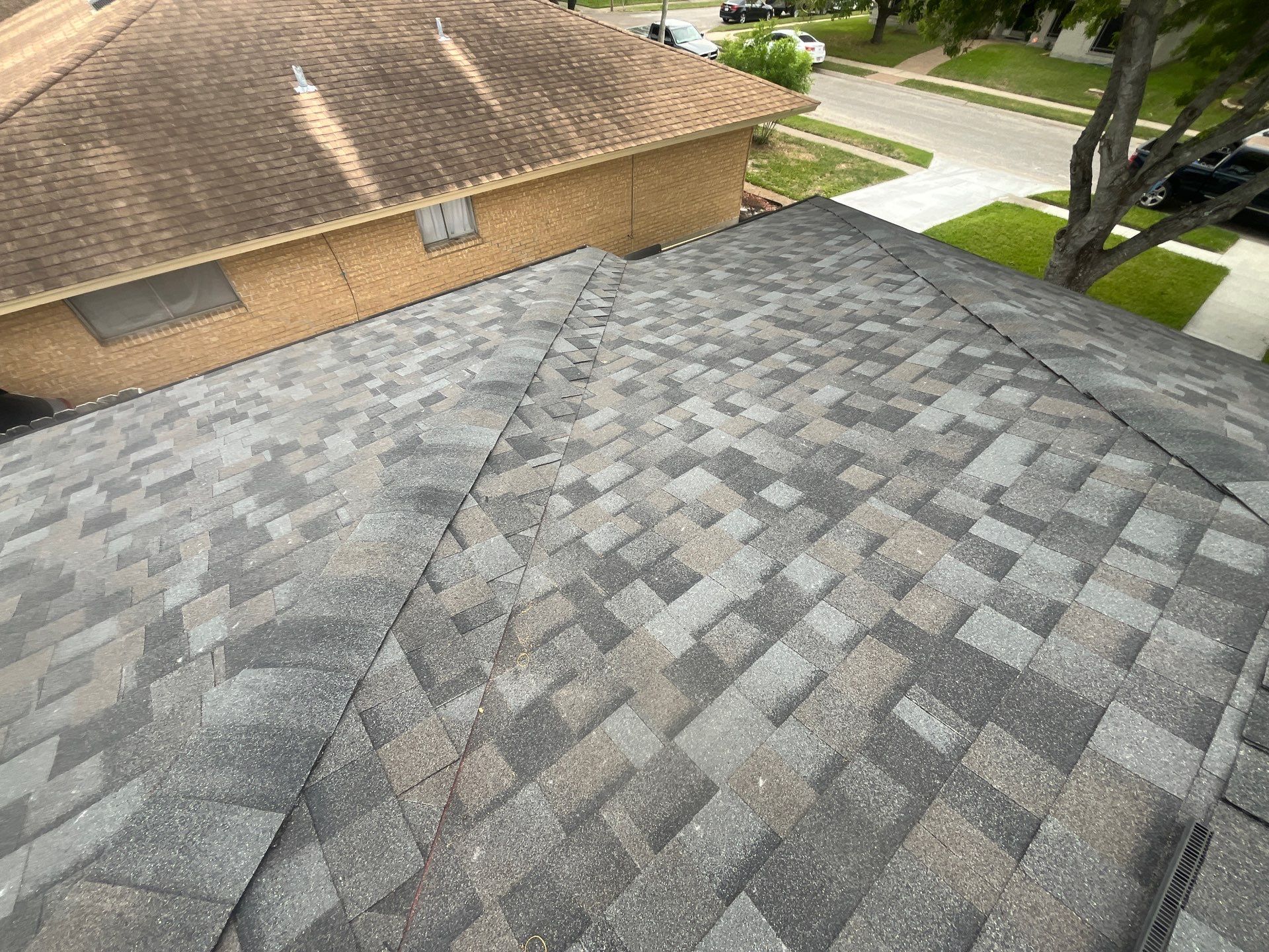 Colored Vinyl Windows to blend into brick by Bayfront Roofing and Construction