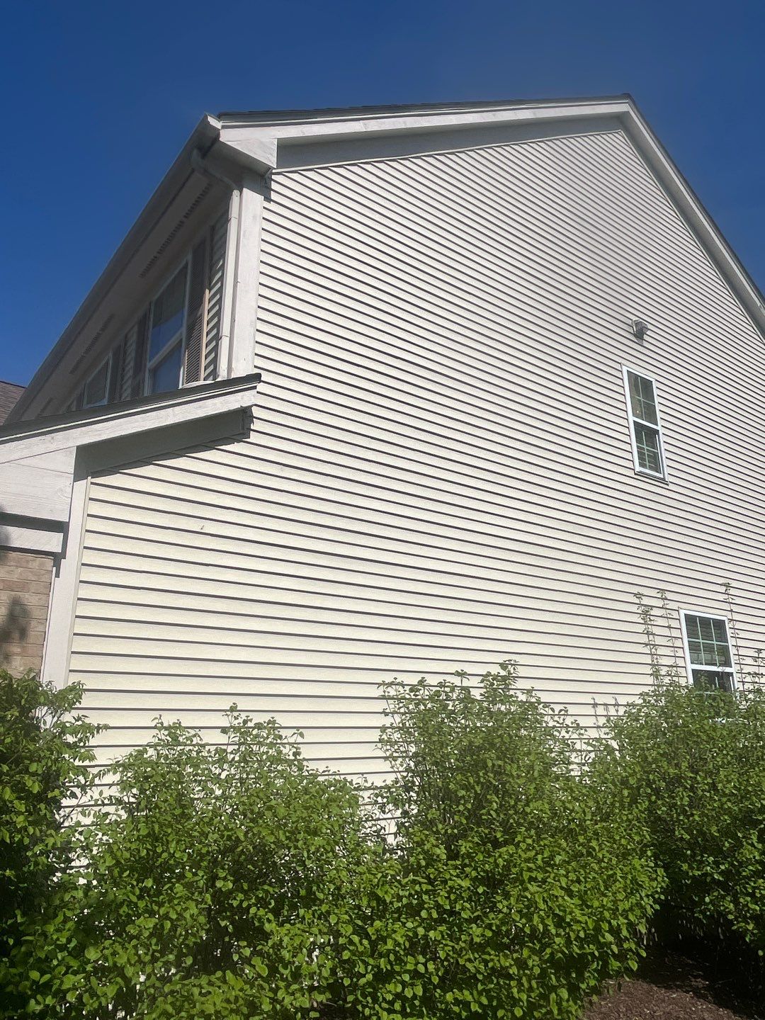 Housewashing  using Algaecide, soft wash soap by Northern Power Washing LLC.
