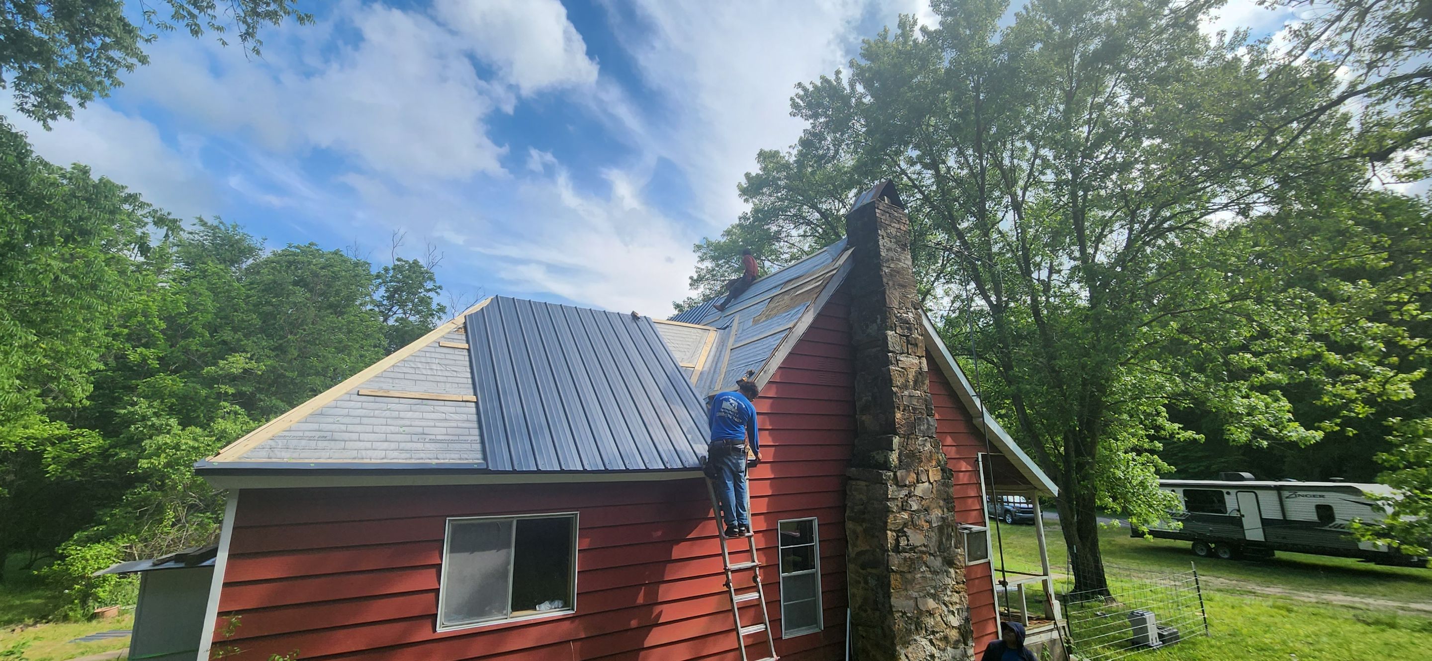 Residential Roofing Installation using 26 Gauge Colored Panels by Hostetler Roofing